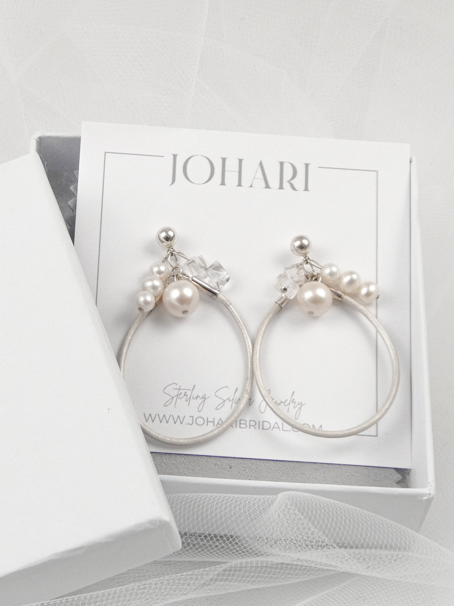 Leather hoops with freshwater pearl, quartz crystals, and sterling silver.
