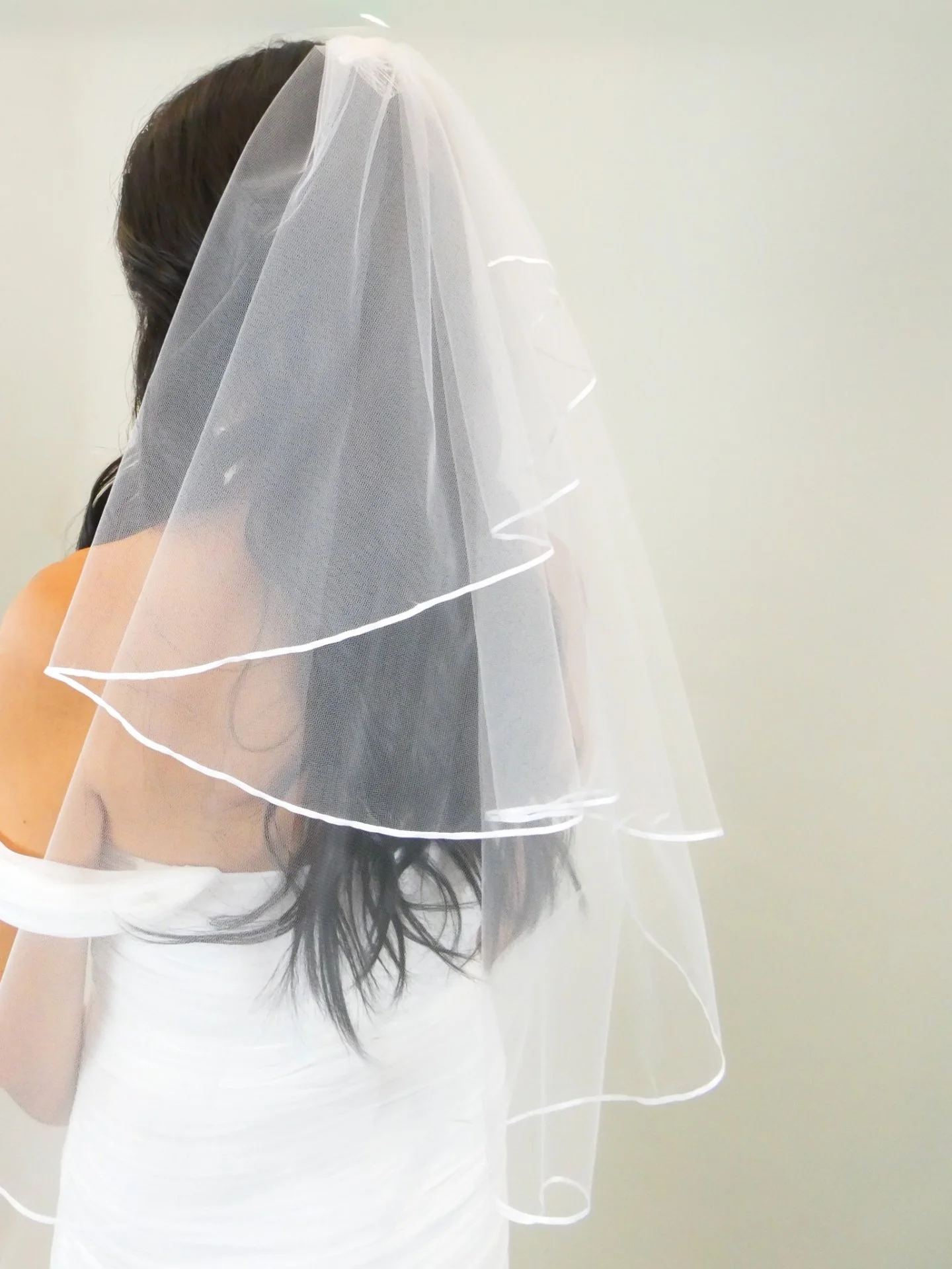 A little bit of fun, a little bit of romance.

This layered veil adds movement and dimension without distracting from the gown, a classic look with just the right amount of personality for you to shine.