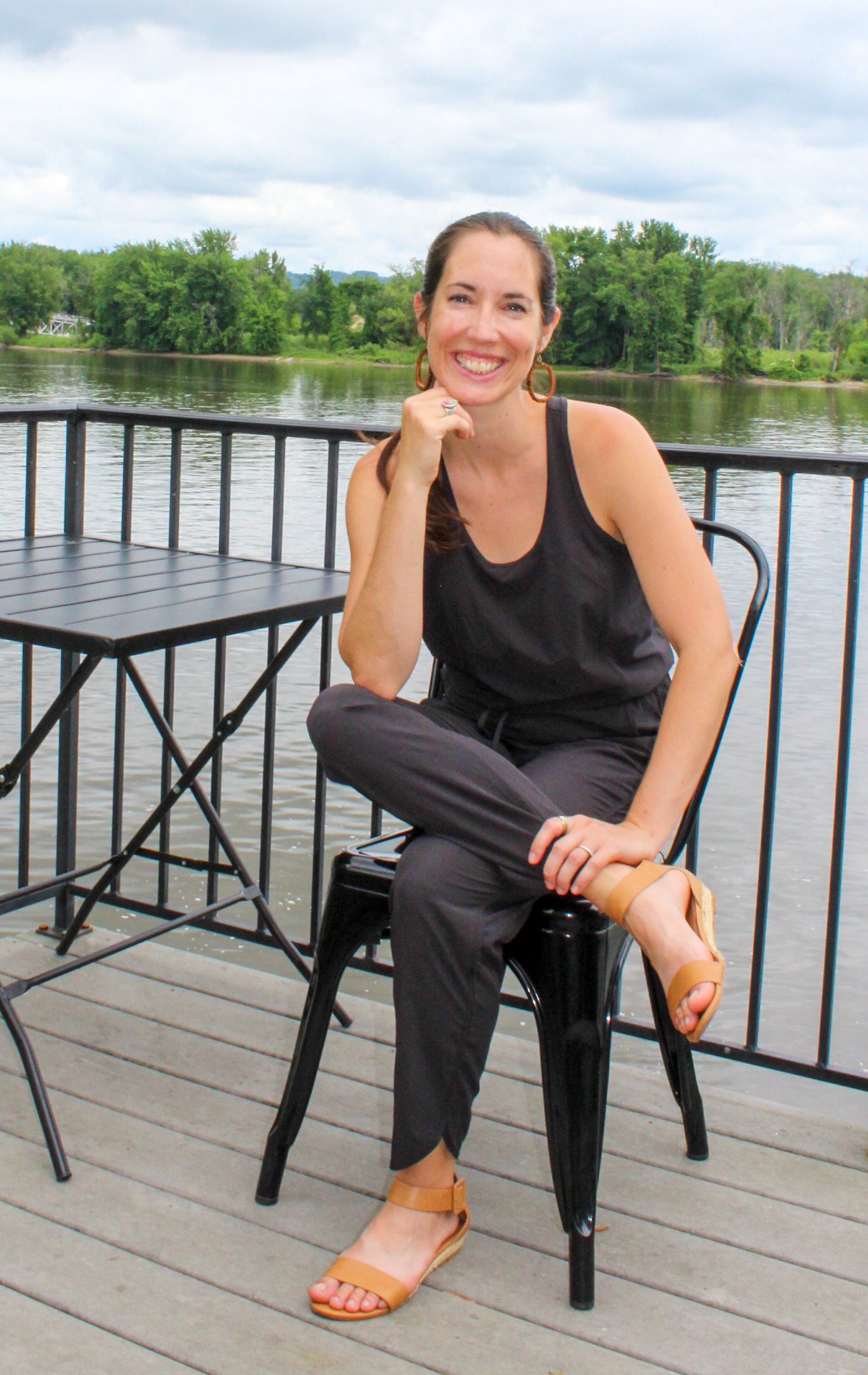  Posed photo of a female life coach with the mississippi river in the background in Lansing, Iowa.    