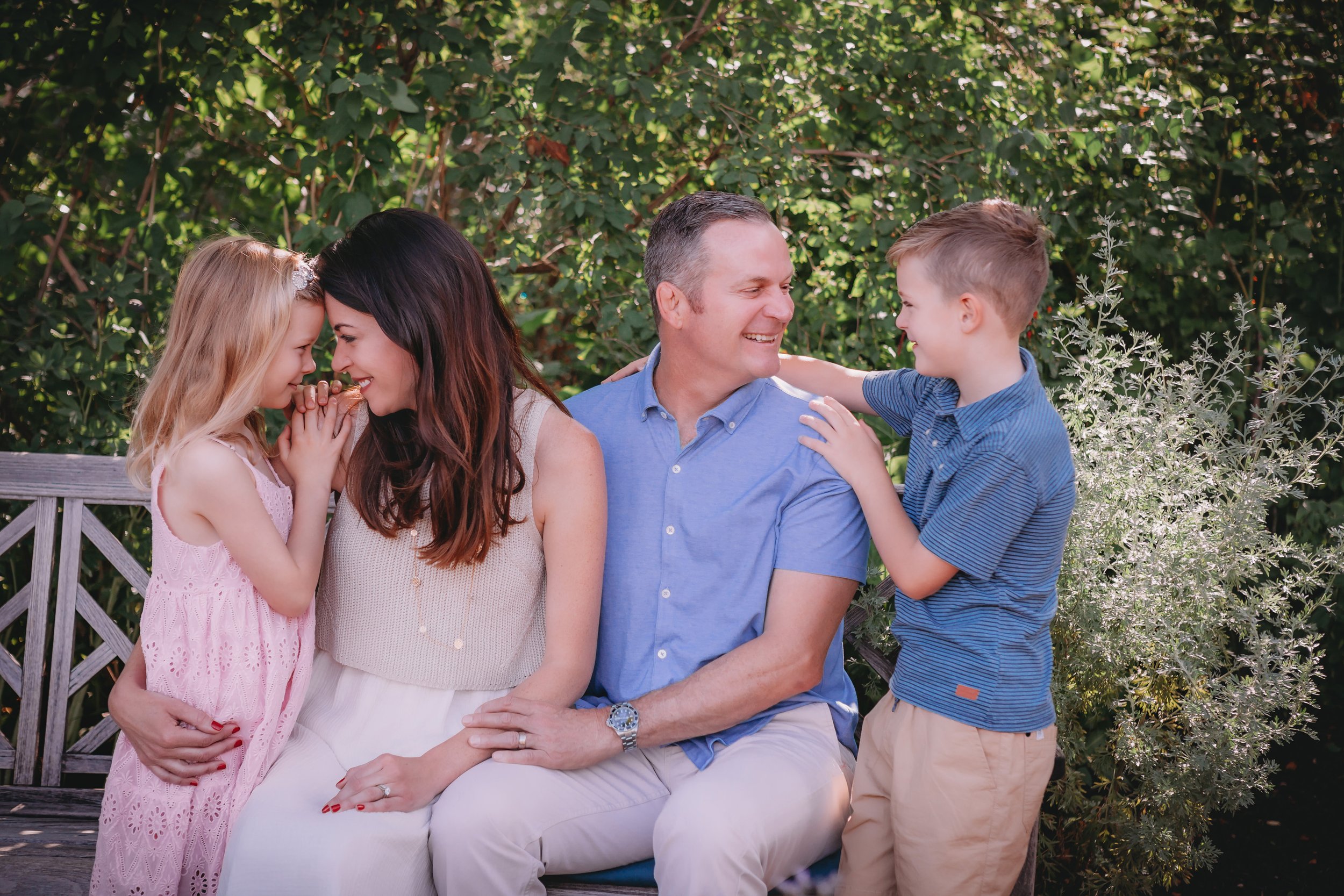 Family portrait outdoors with greenery