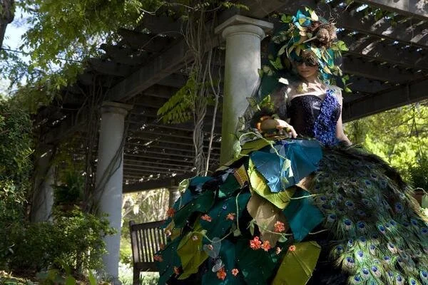 I designed, sewed, painted and embellished this gown. It is adorned in sculpted silk leaves, silk wrapped wire vines, organza butterflies, thousands of hand sewn sequins and hundreds of Swarovski crystals.  This is one of my greatest designs.