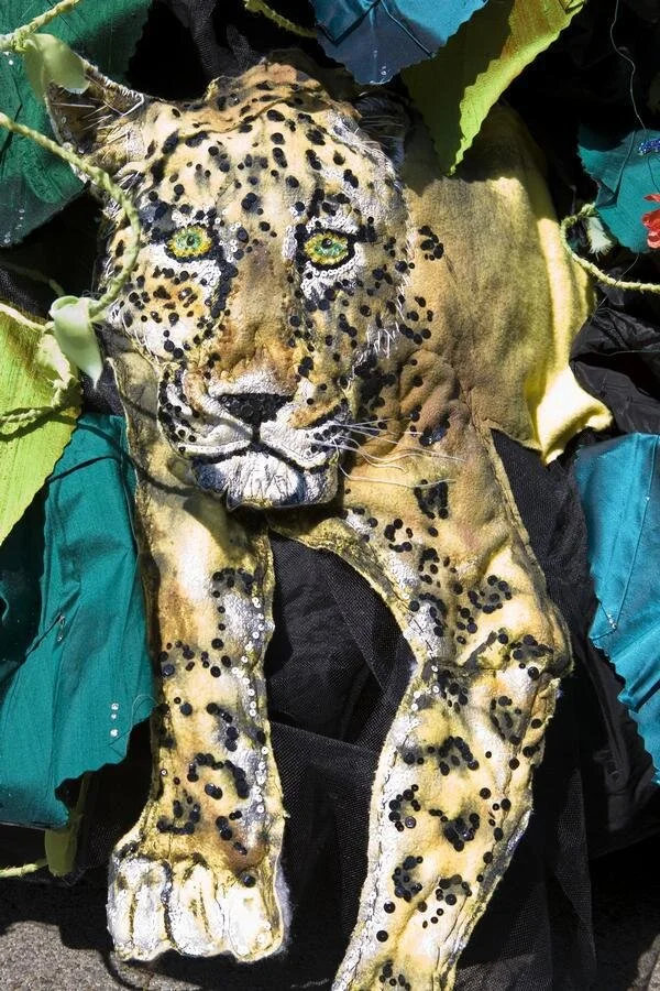 This Leopard is made of fabric that I quilted to add depth.  Then I hand sewed sequins for his spots.  