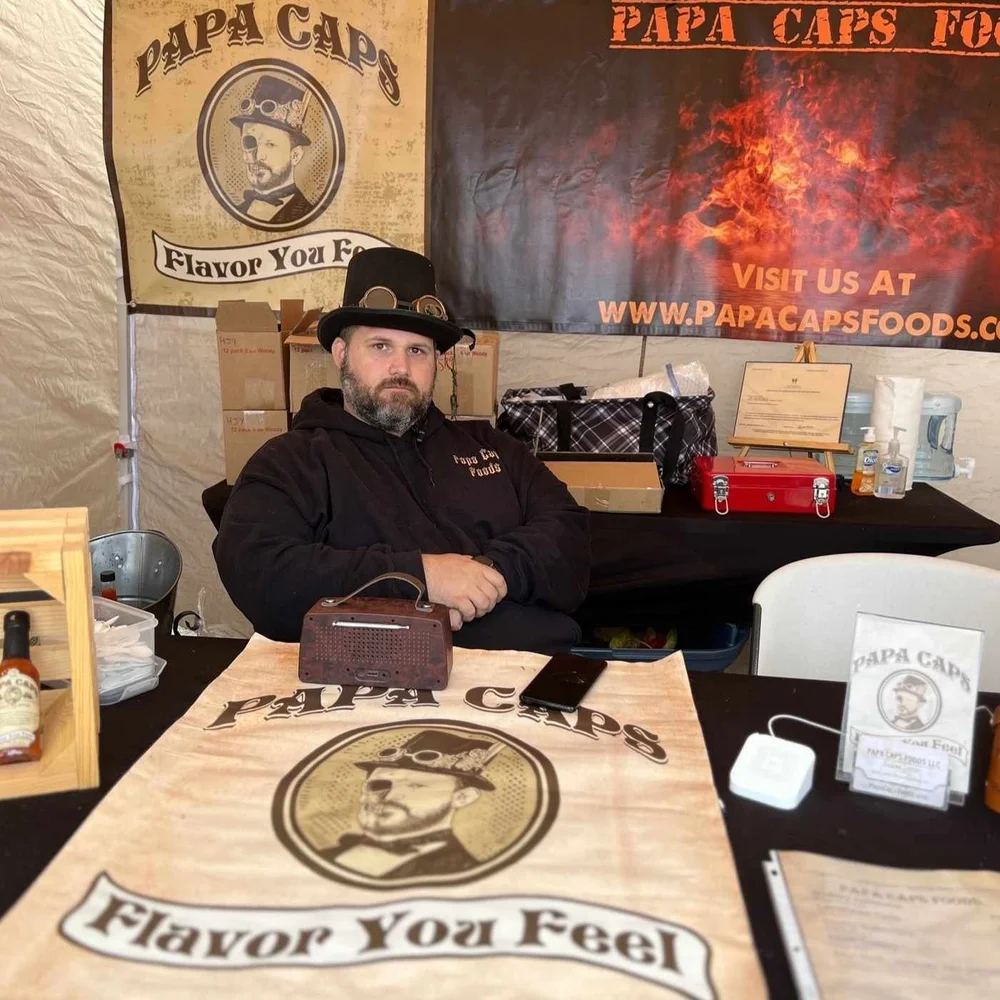 Luke Lentz, founder of Papa Caps Foods, wearing his signature top hat and goggles