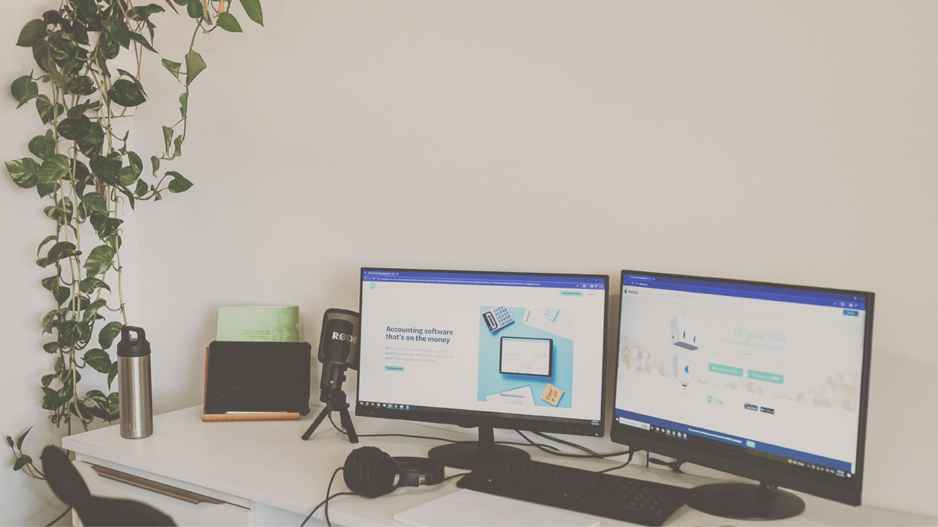Featured image of Bookkeeping software for construction business blog with two monitors on the table
