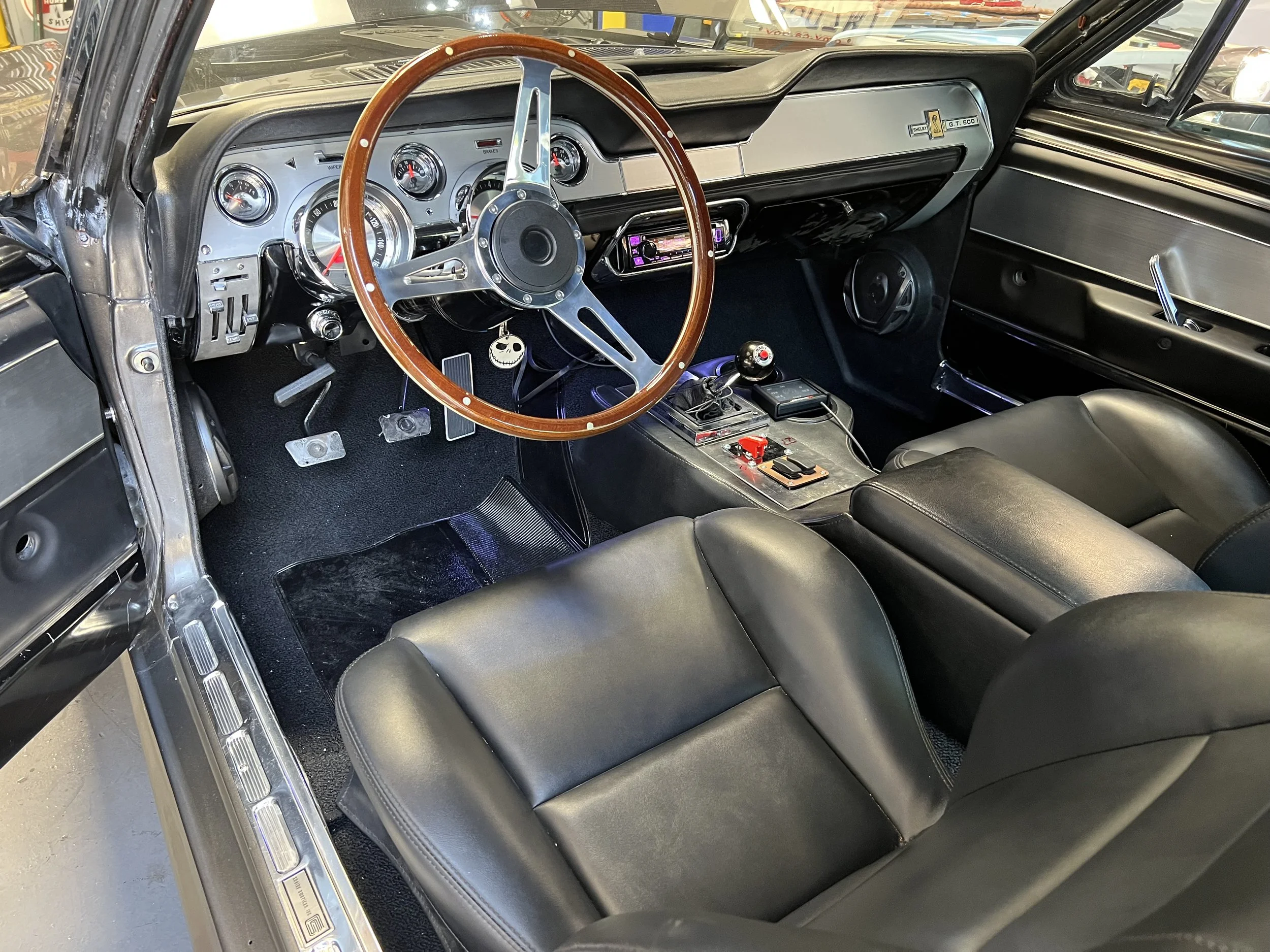 67 E Car with the Shelby Deluxe interior, feathering Autometer American Muscle Series for the gauges  