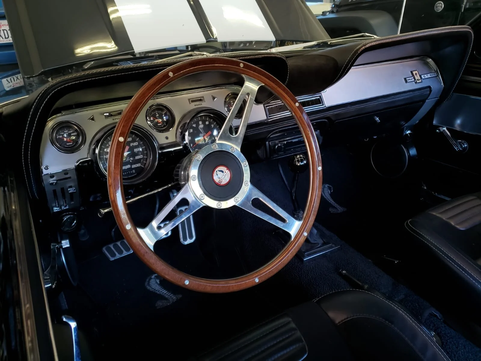 67 Shelby Deluxe Brushed Aluminum Interior w/Custom Shelby Gauge Package, Painless wiring, Power Windows & Door Locks using factory style switches, 5 Speed Manual Transmission, Lokar Pedals, Alpine Deck w/kick panels, 6.5" speakers in front 6x9"s rea
