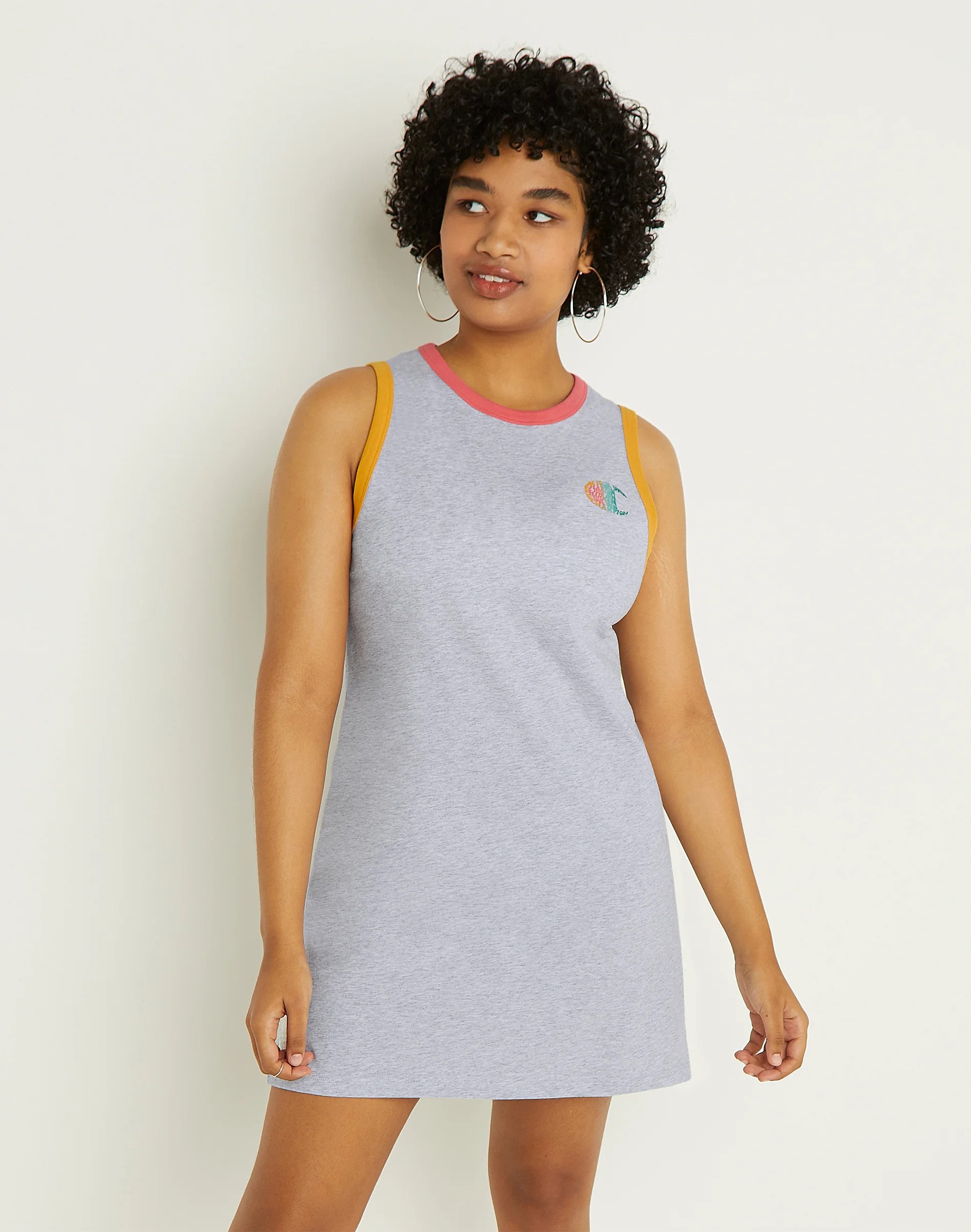 An ad for Champion depicting a model wearing the Campus Tank Dress. Be your own Champion in the size Small and the Oxford Grey Heather/Multi color.