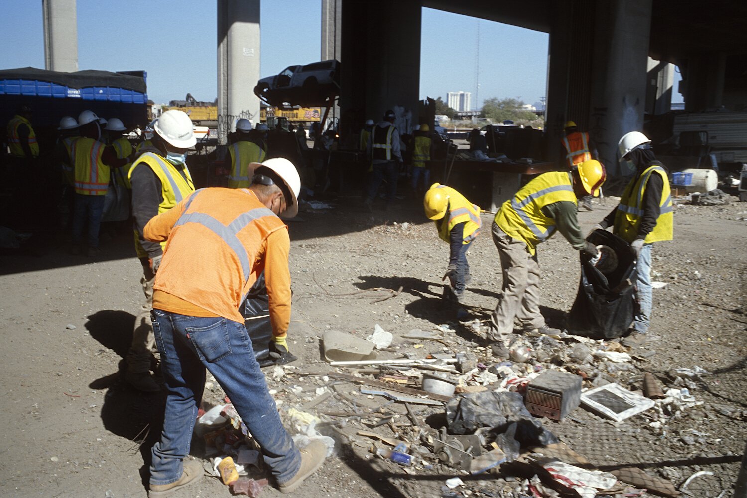Workers picking small debris — Oakland, California