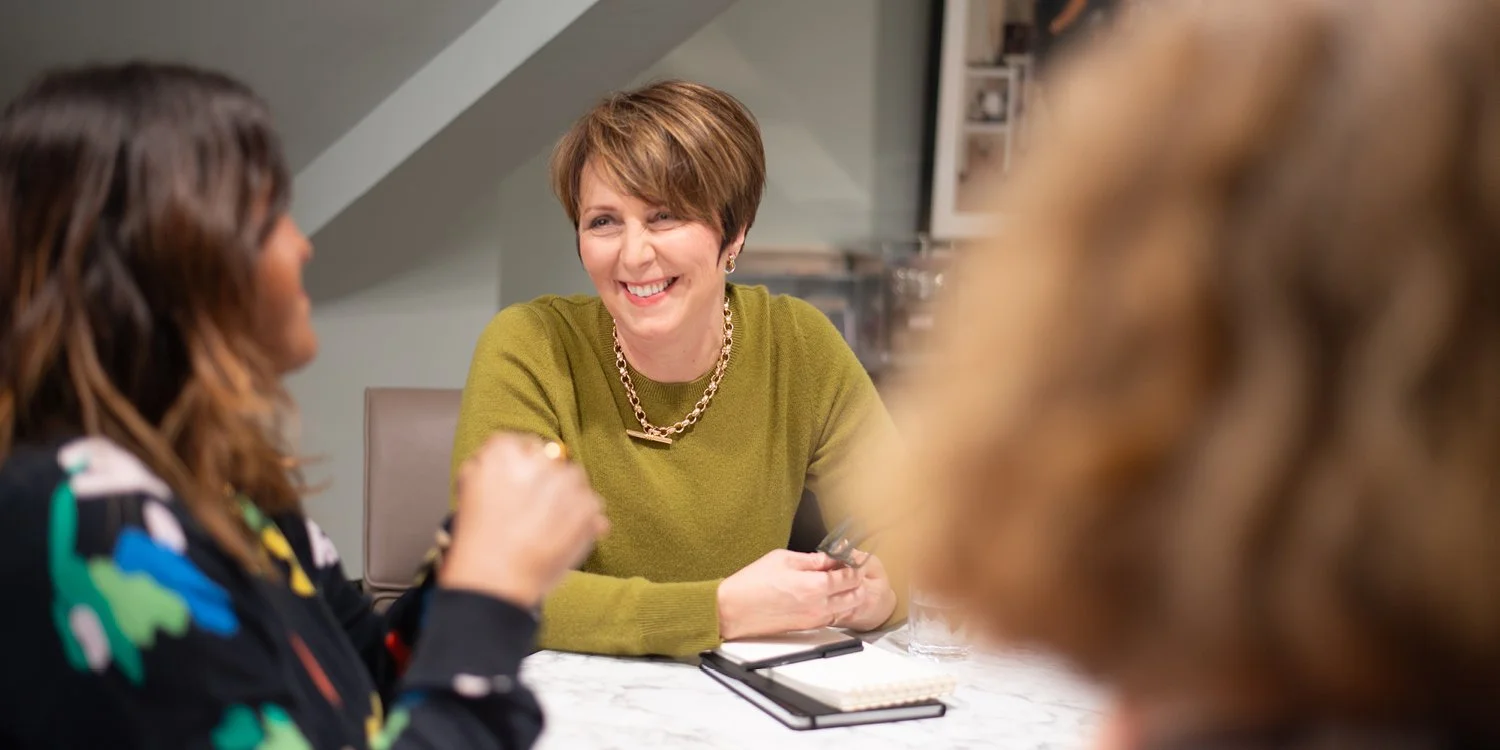 Image of Zoe in discussion with another woman