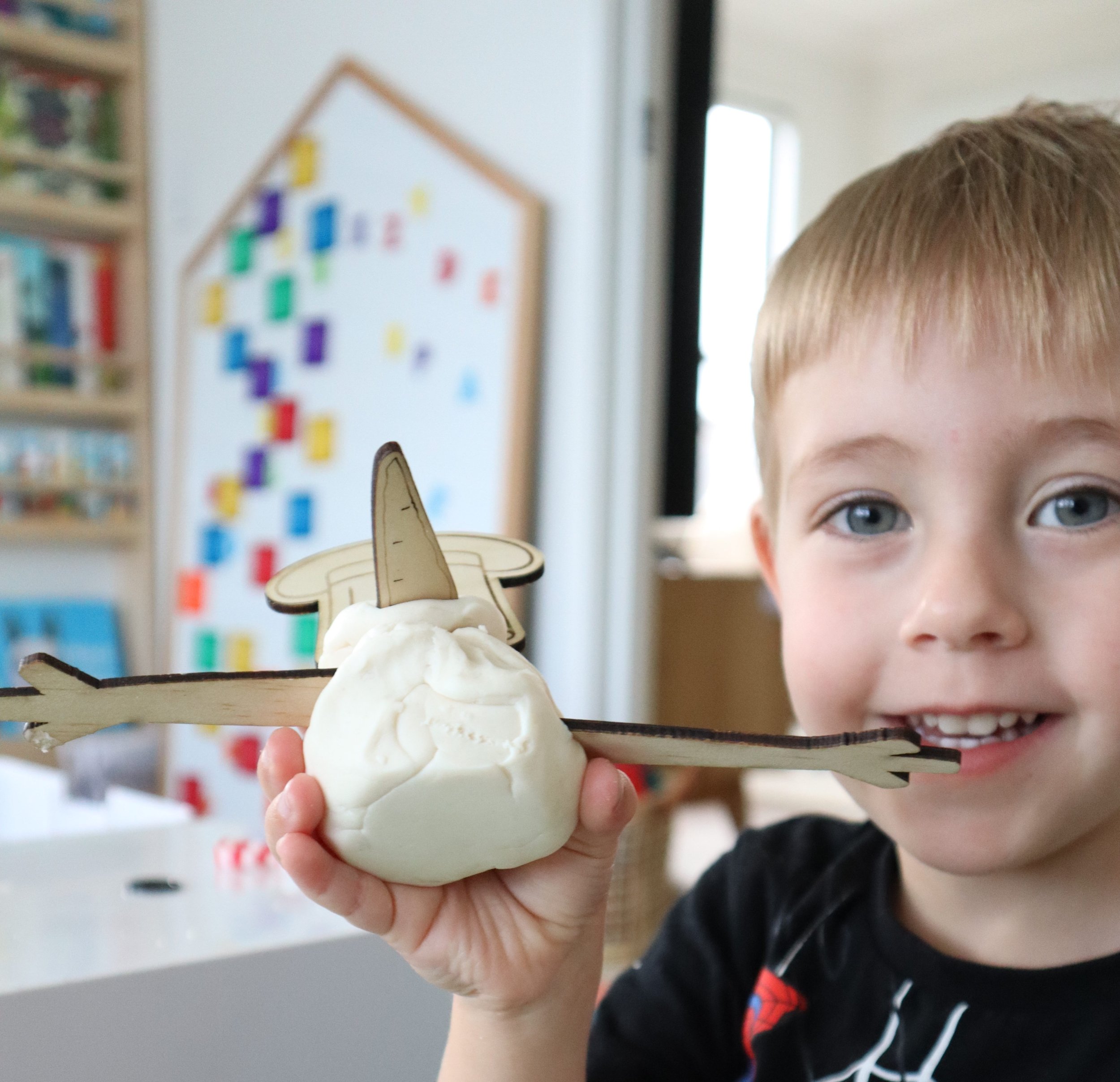 Holiday playdough kit featuring snowman-themed accessories and sensory tools.
