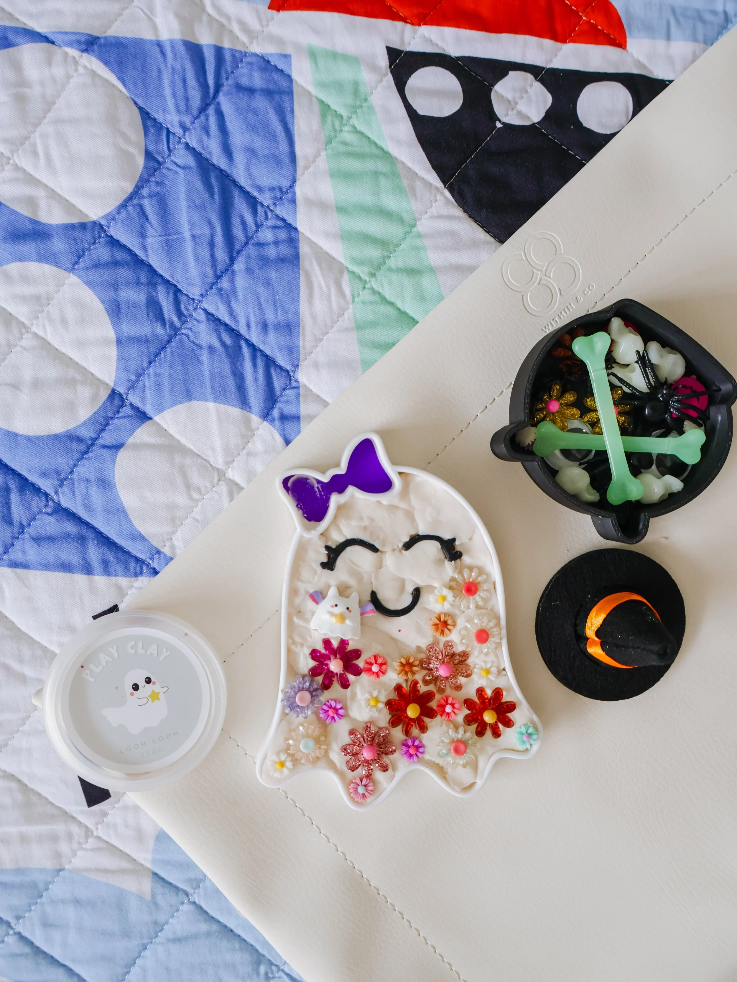 Spooky sensory play setup for children using Halloween-themed loose parts and sensory fillers