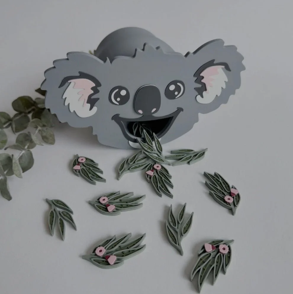 Child feeding eucalyptus leaves to a sensory play koala