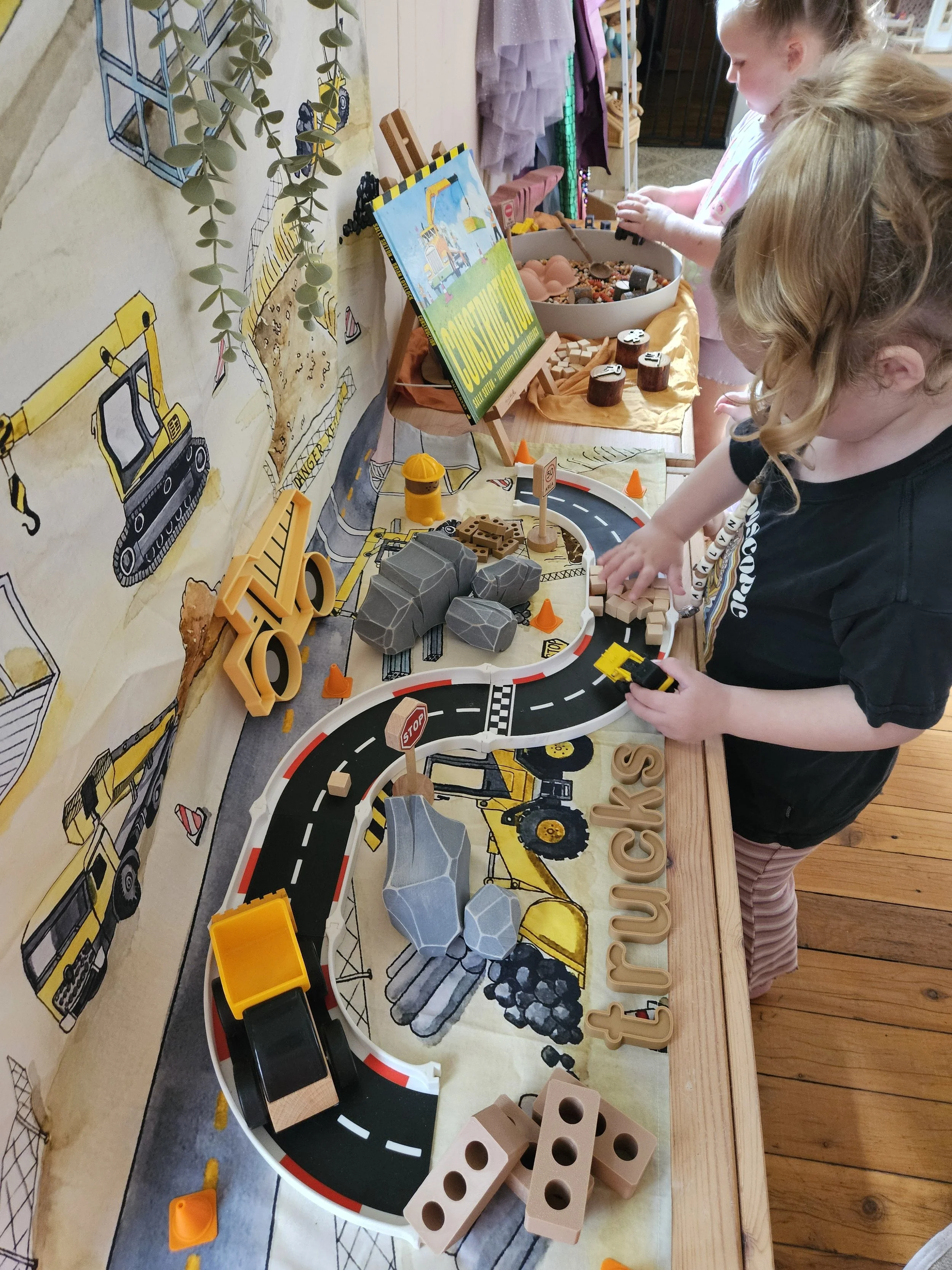 child playing with mini bricks in a construction zone small world