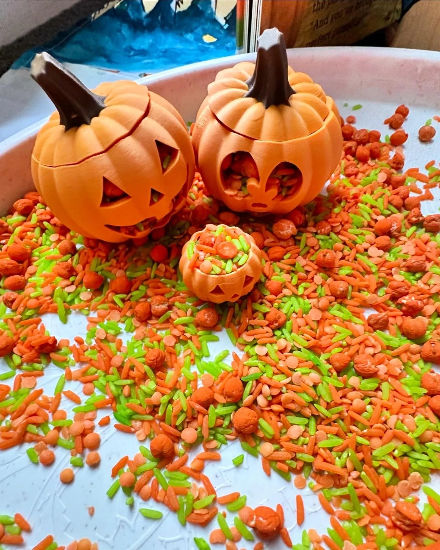 Halloween sensory play invitation featuring themed loose parts, scoops and sensory materials for open-ended exploration