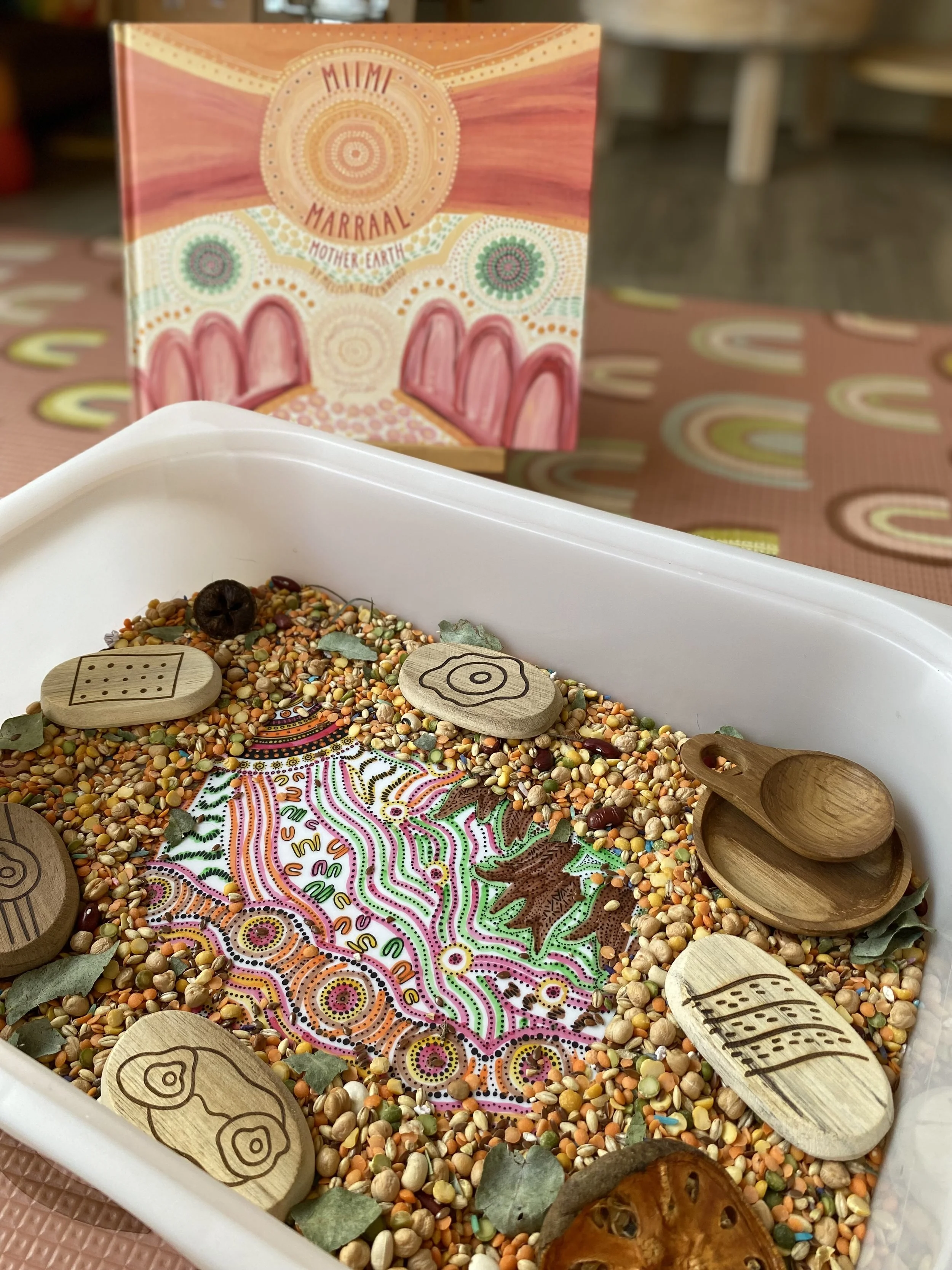 Children engaging with an Australian storybook and loose parts play to extend learning through creativity and imagination.