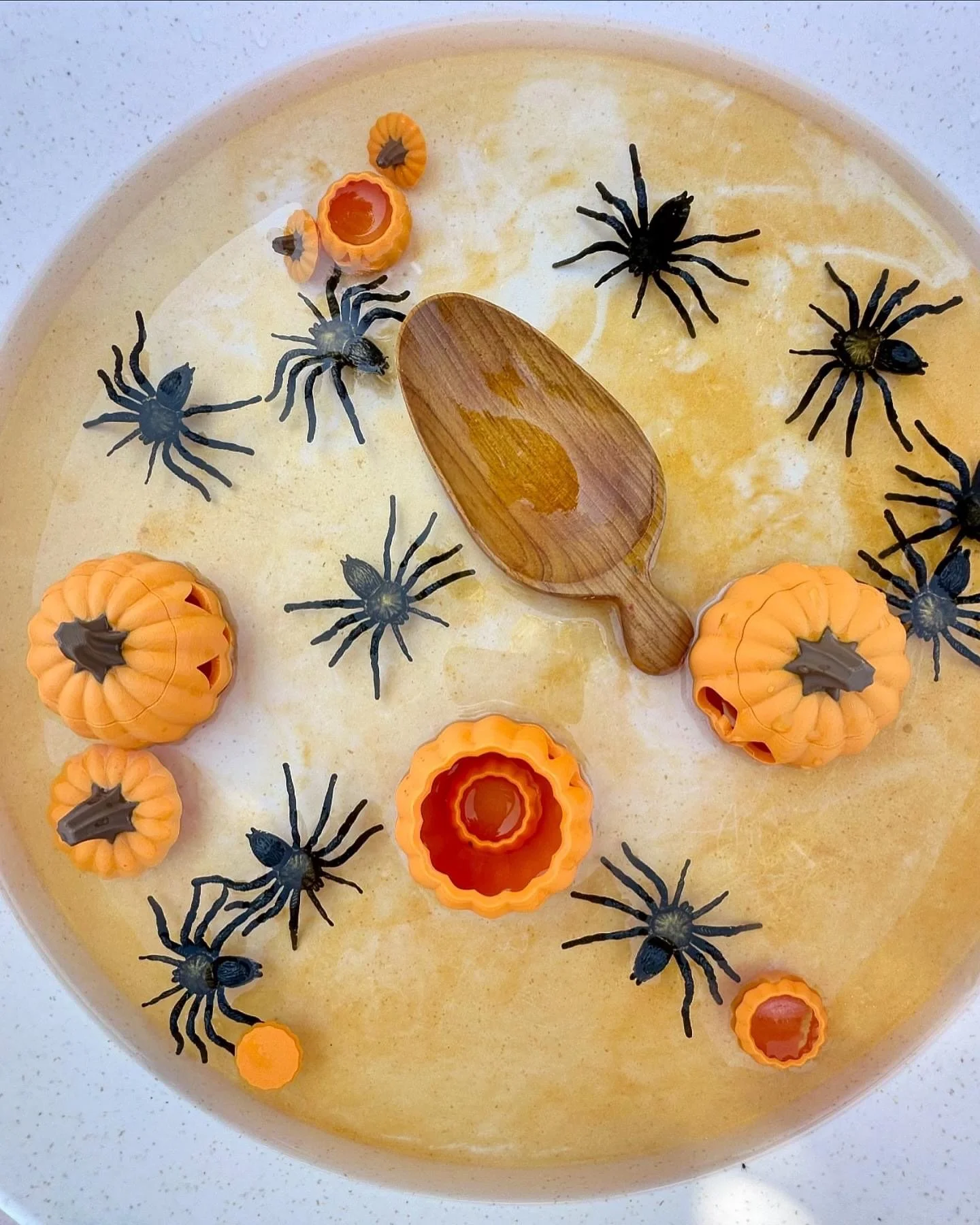 Spooky sensory play setup for children using Halloween-themed loose parts and sensory fillers