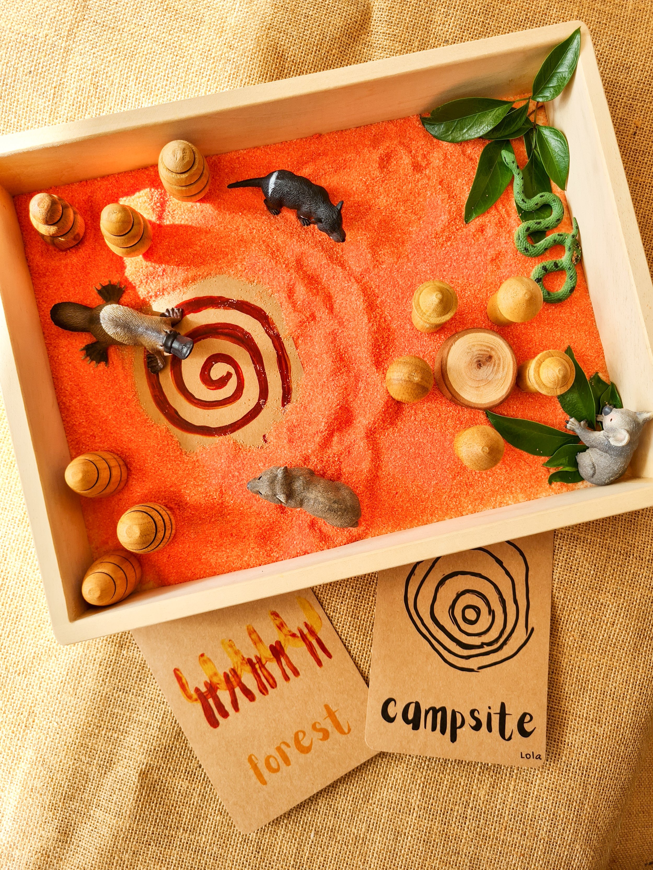NAIDOC Week sensory play invitation featuring earthy sensory base colours, Australian animal figurines and open-ended learning materials.