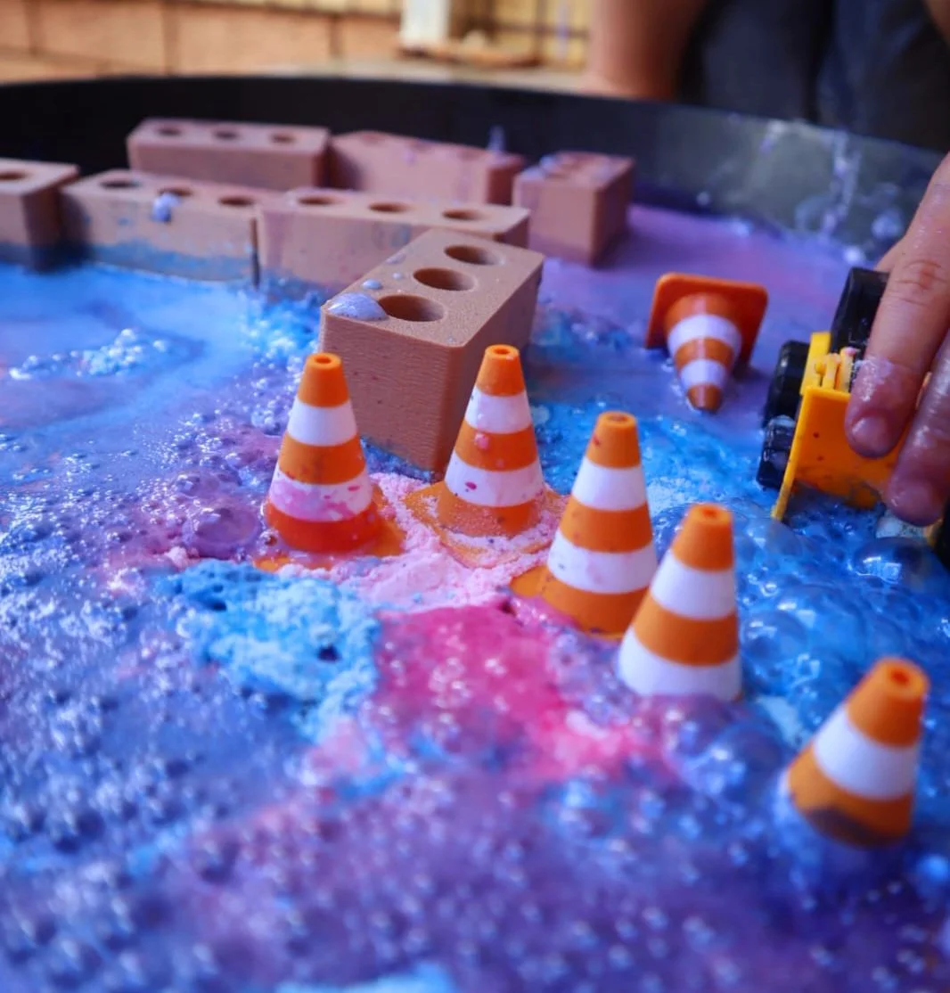 Construction fizz play activity with mini bricks, traffic cones and sensory play ingredients.