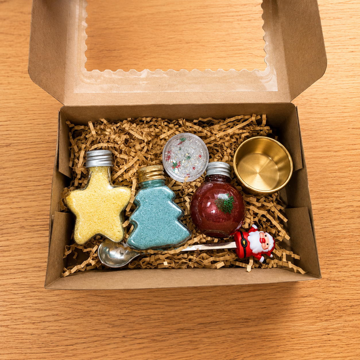 Open Elf Magic Potion Kit showing tree and star fizz baubles, shimmer potion bauble, Elf Dust, black bowl and Christmas spoon.