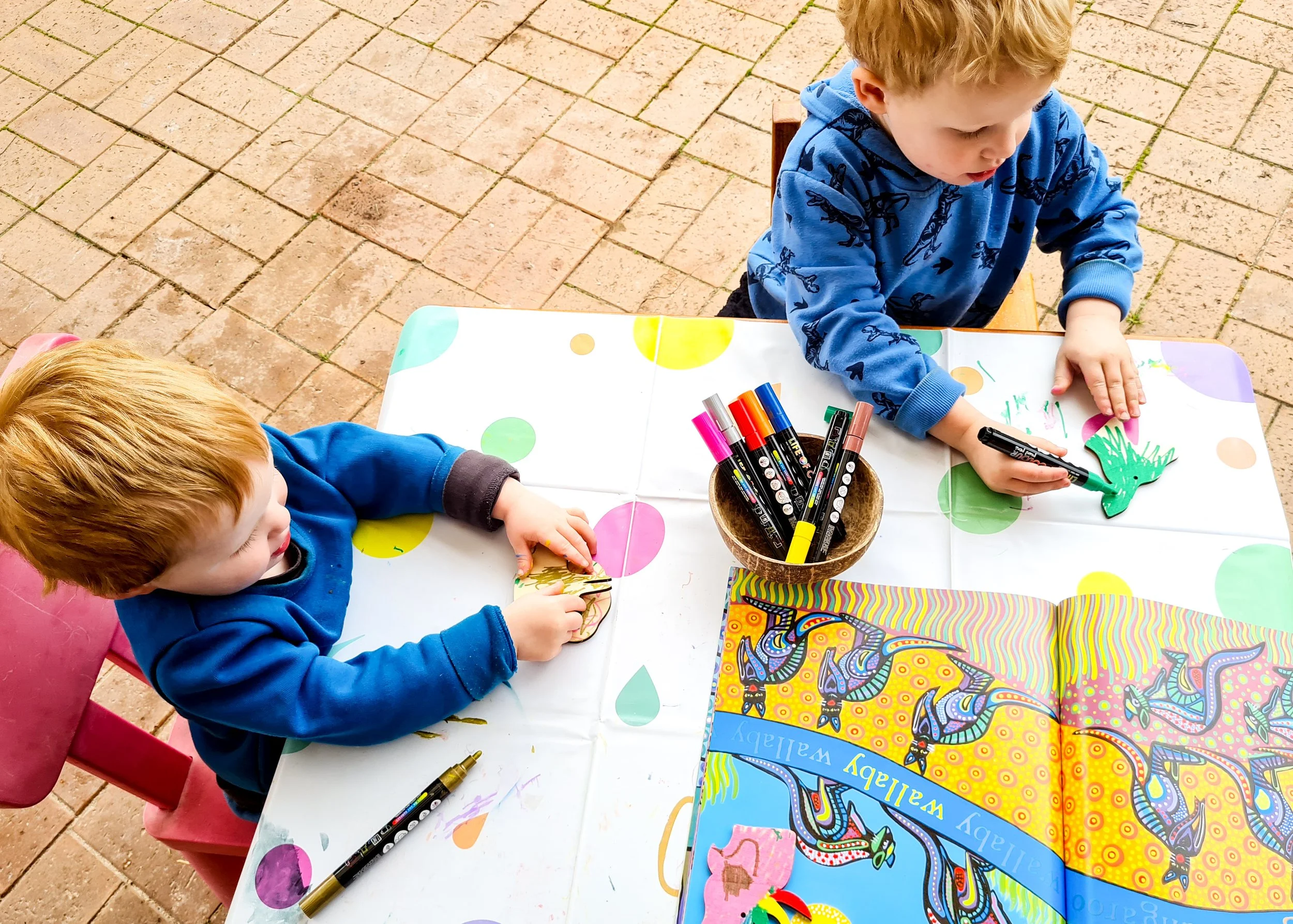 Children making an Australian-themed craft during NAIDOC Week using natural textures, colours and creative play resources.