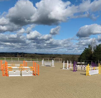 Joe-Macdonald-Showjumper-show-jumping-training-lessons-course-arena-hire-Gloucestershire-british-showjumping-coach-hooze-farm-stables-livery-outdoorarena-arenahire-outdoor-showjumping-showjumps-surface.jpg