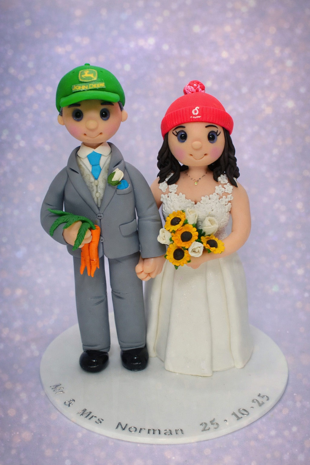 Farmer bride and groom wedding cake topper with groom holding a bunch of carrots.