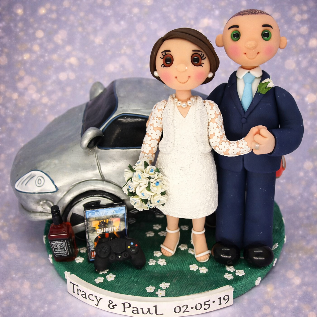 Personalised wedding cake topper with bride, groom , car, bottle of Jack Daniels and video game. 