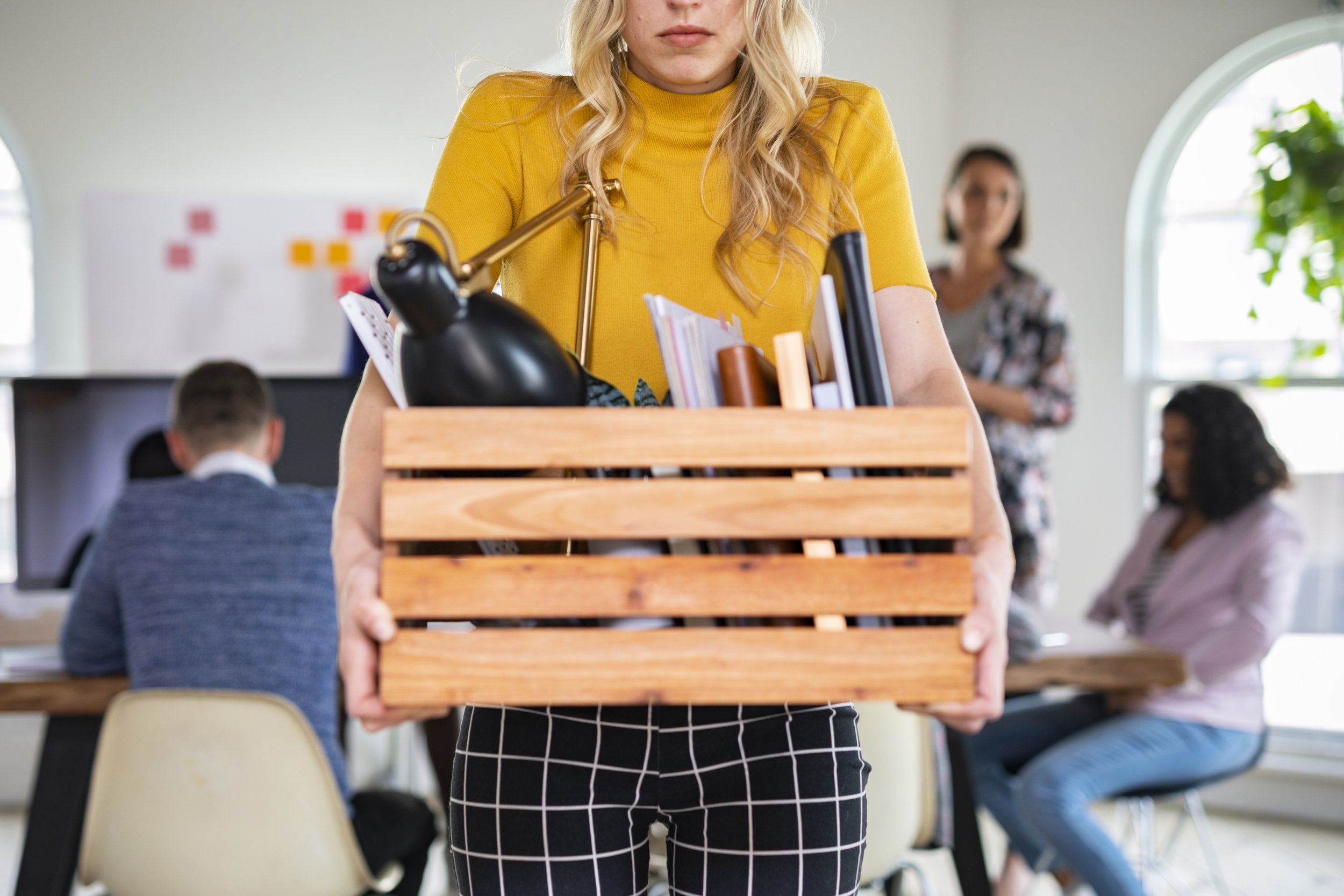 young-businesswoman-carrying-a-wooden-box-2022-12-16-00-06-48-utc.jpg
