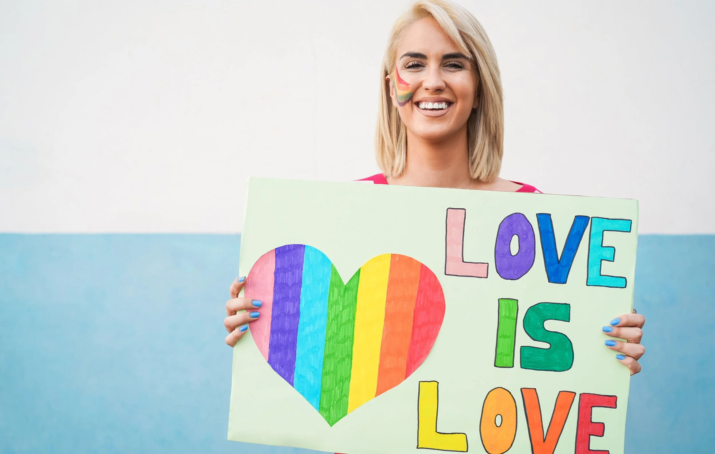 portrait-of-gay-woman-holding-love-is-love-banner-2021-09-03-01-28-24-utc.jpg