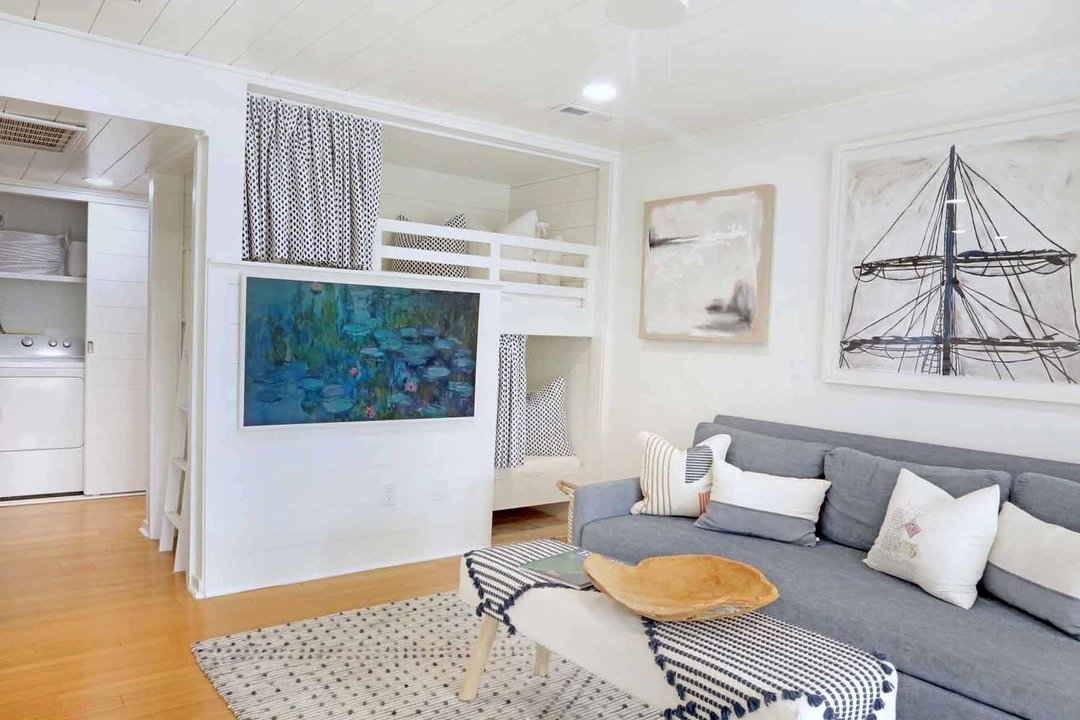 Step into our transformed living room, where beachy vibes meet cozy relaxation with tucked-away bunk beds. Perfect for unwinding and creating cherished memories with family and friends.
