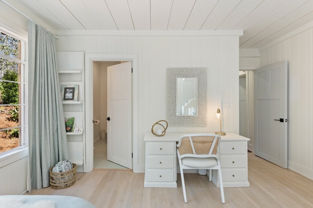 Step into our transformed bedroom sanctuary, where every detail is designed for serenity and style. Our vanity, with a large mirror above, adds a touch of elegance and functionality to your daily routine.