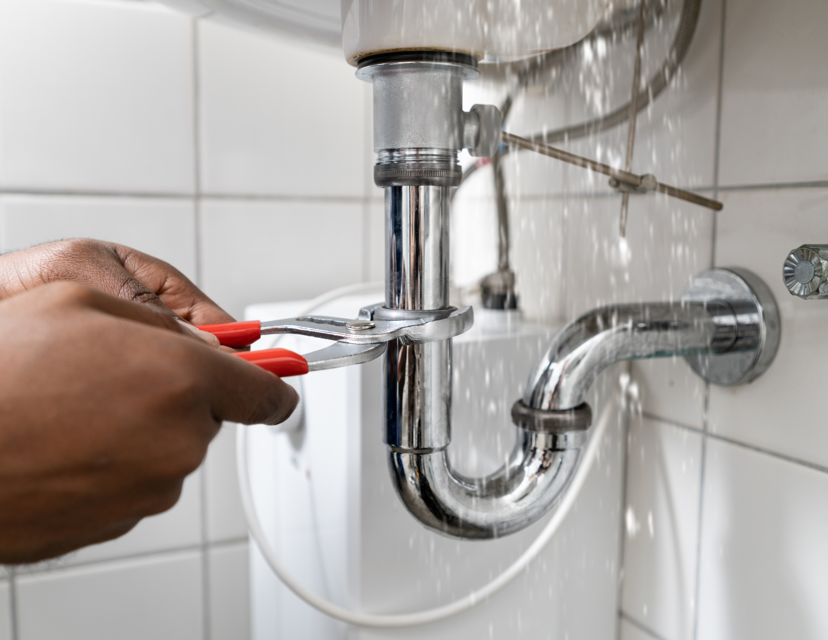 A professional plumber utilizing specialized tools to repair a kitchen sink pipe, showcasing premium home repair services in dallas.