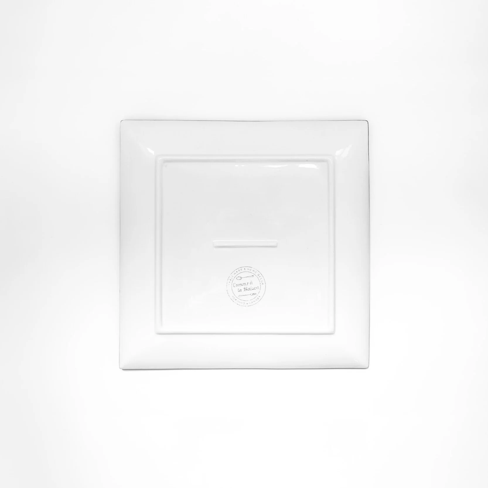 Back view of a large square platter with Canadian symbols on a white background