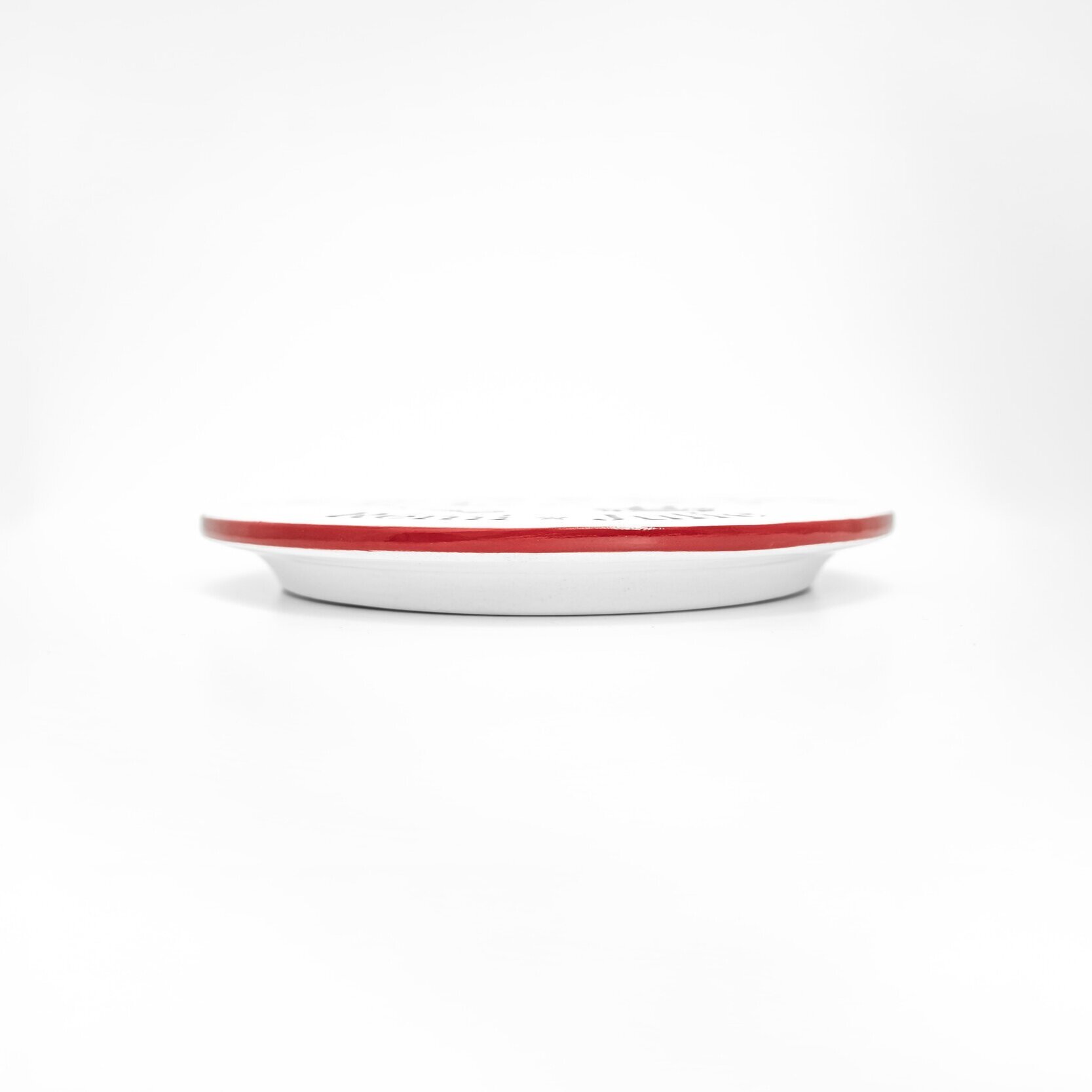 Side view of red and charcoal personalizable trivet on a white background