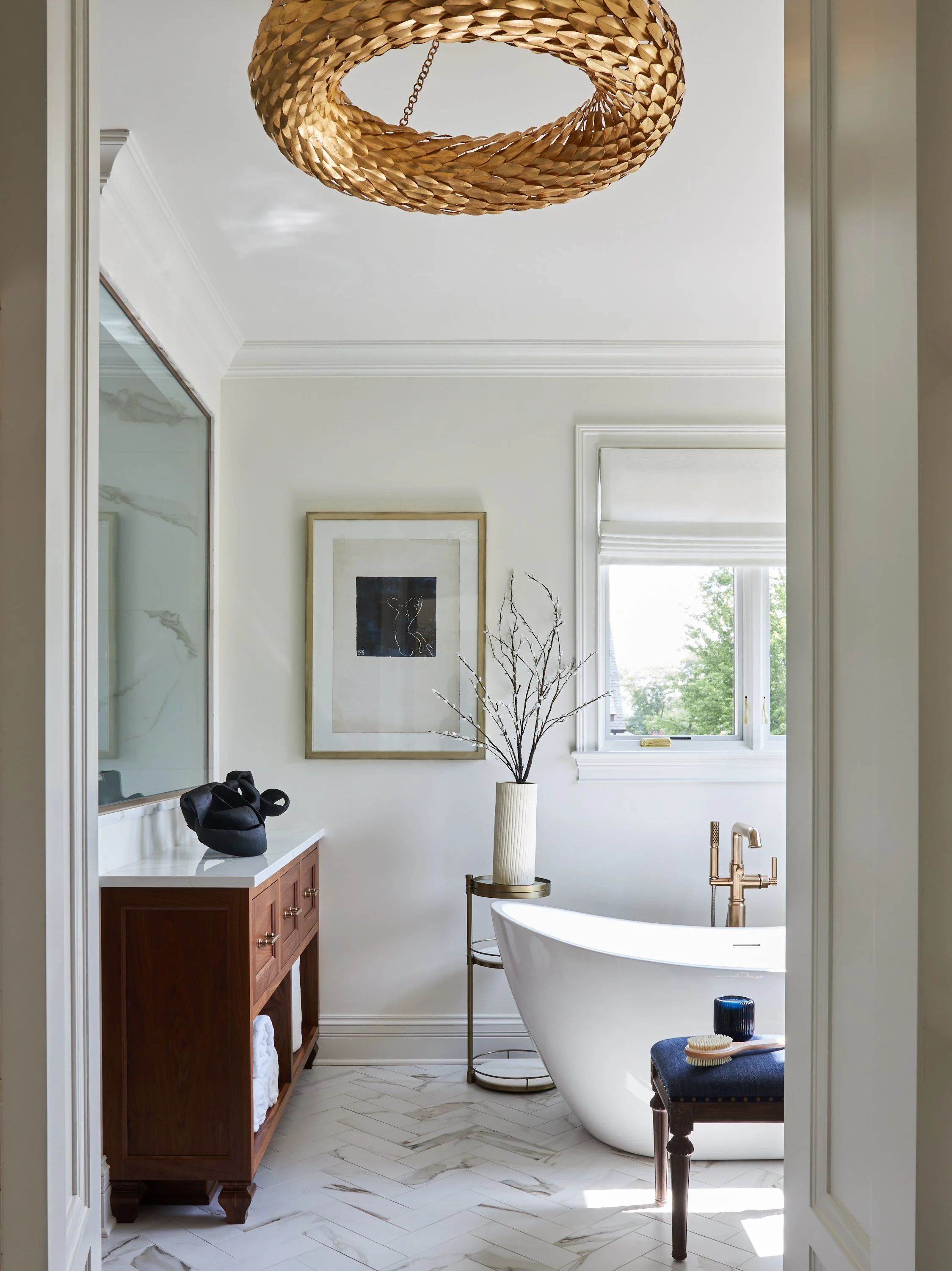 Master Bath with Free Standing tub chandelier  marble herringbone floor and custom cabinetry designed by Tracy Kurc Chicago Illinois