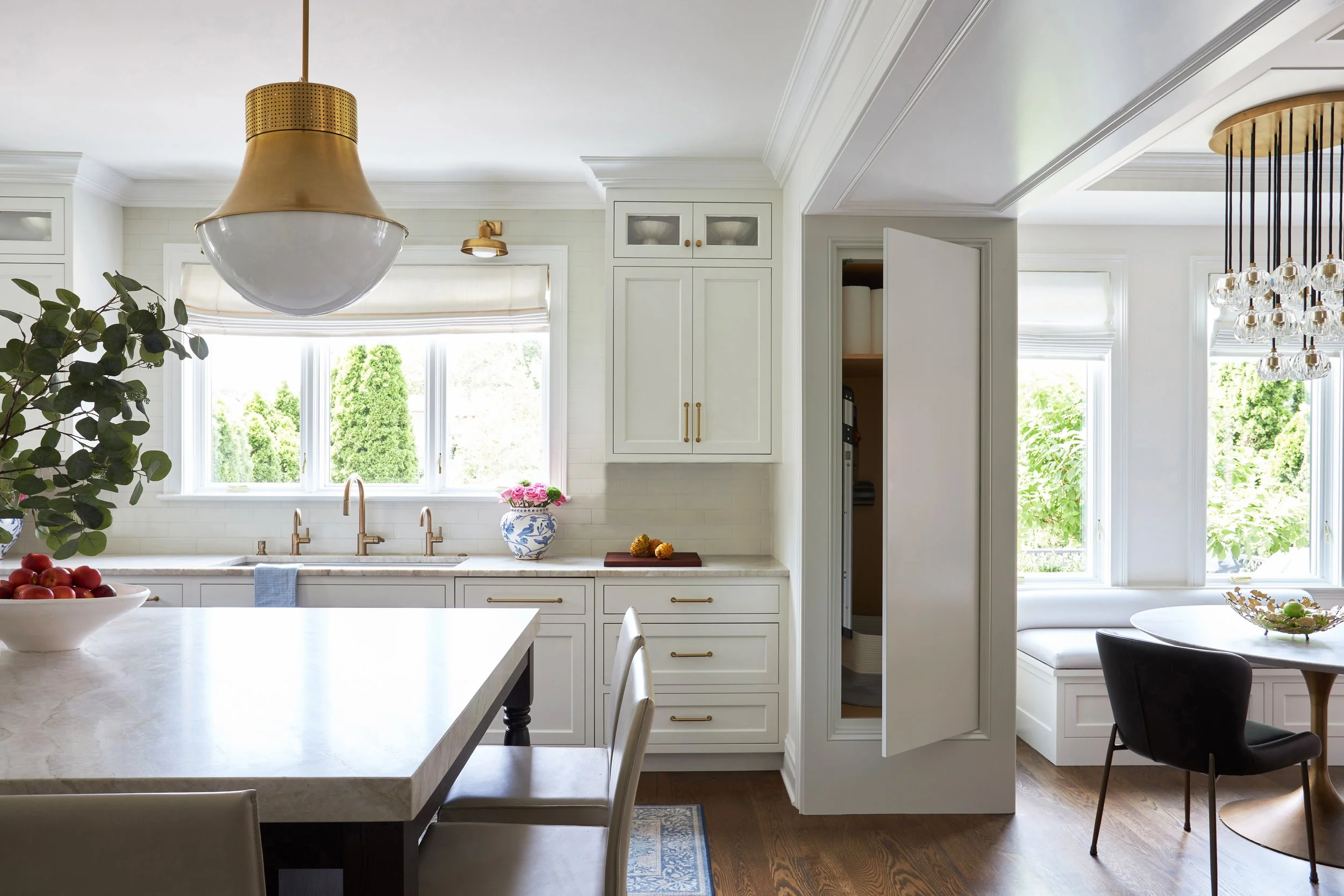 Kitchen that feels modern without being cold.  Warm tones, hidden storage, styled island
