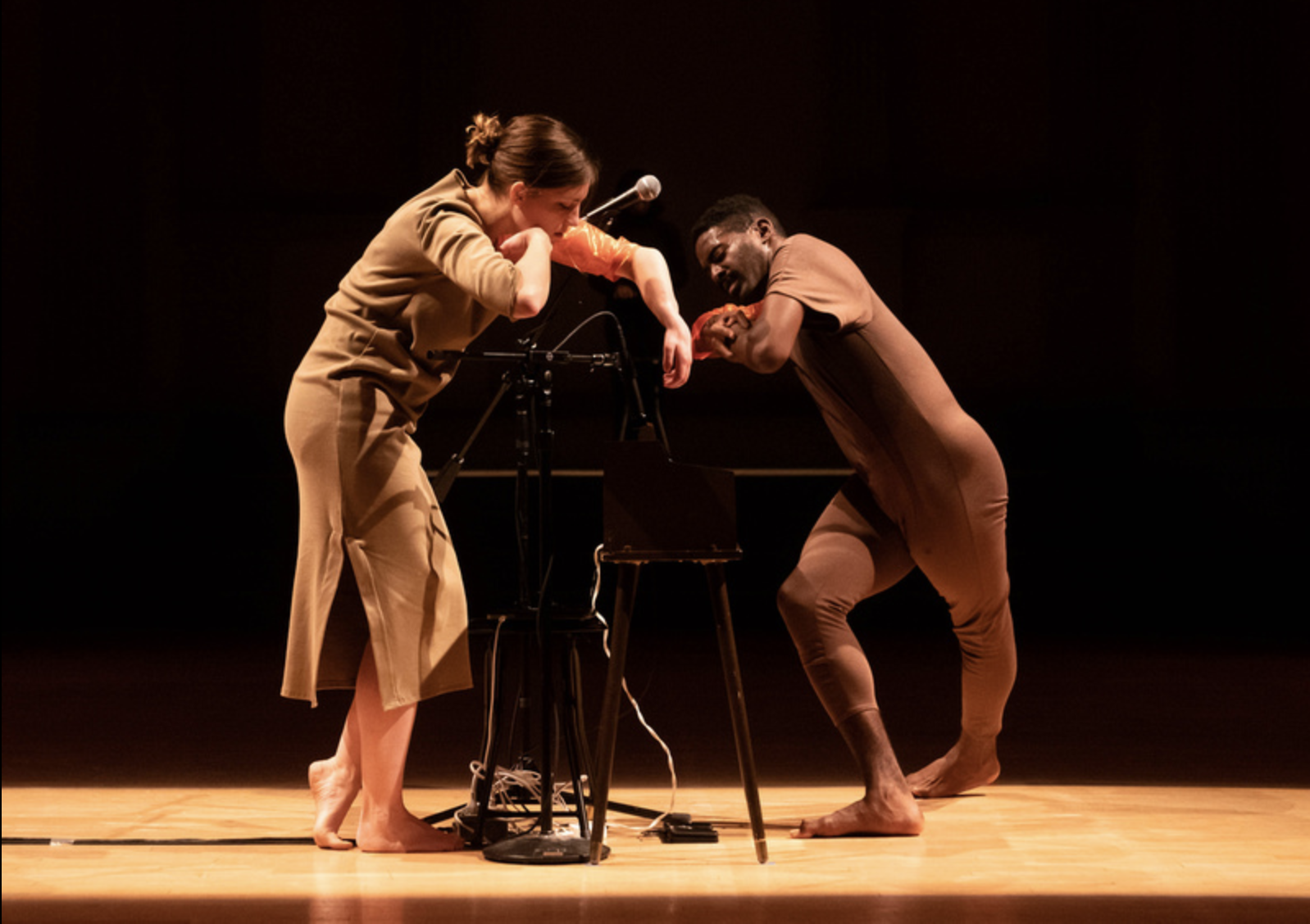 image description: Jerron Herman and I perform above a vintage toy organ, performing "Breaking and Entering" at Danspace Project in New York, NY.