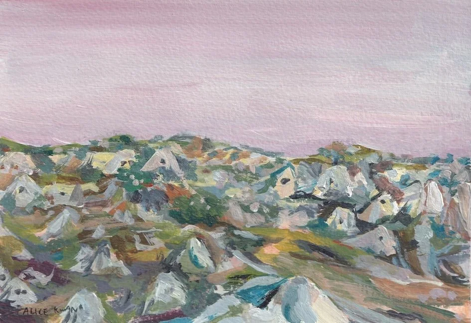 A landscape painting of a rocky hillside with small houses, under a pale pink sky.