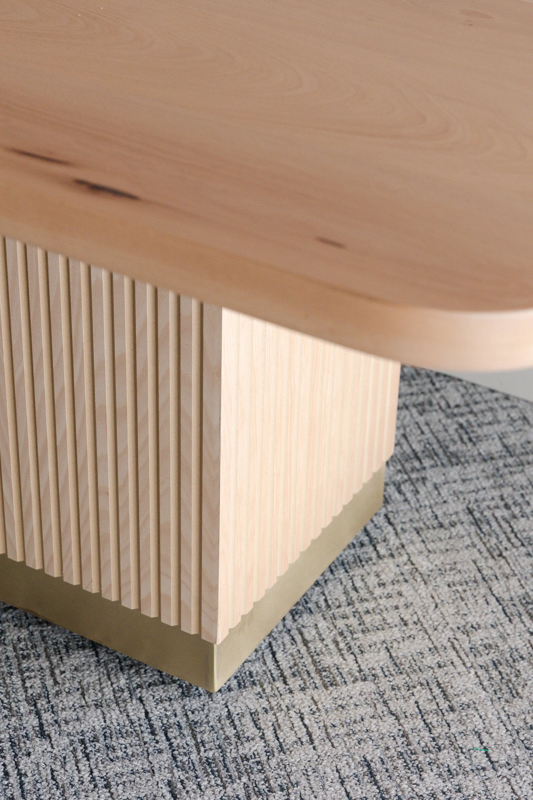 Fluted base dining table with brass detail