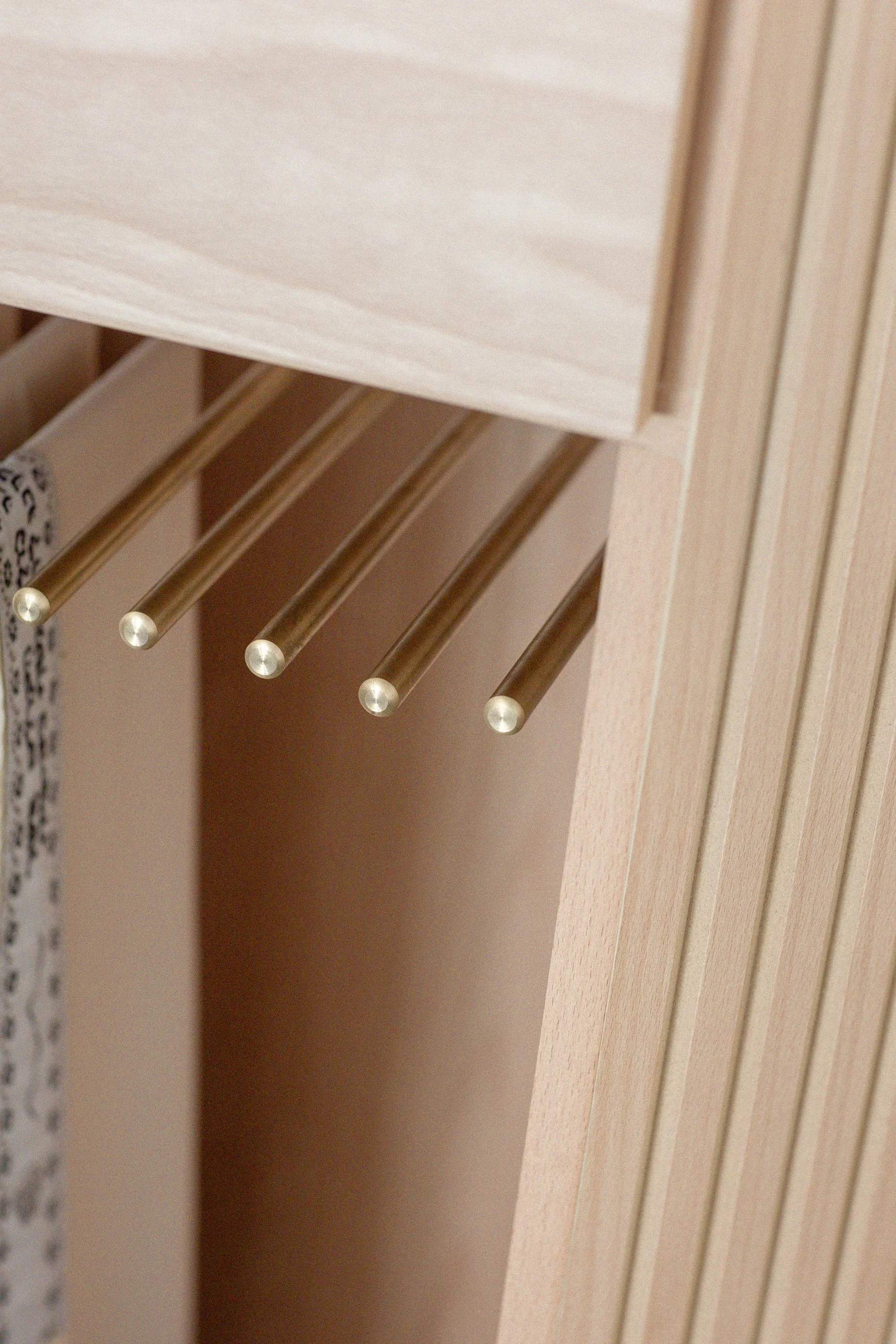 Custom brass rail for solid wood cabinet