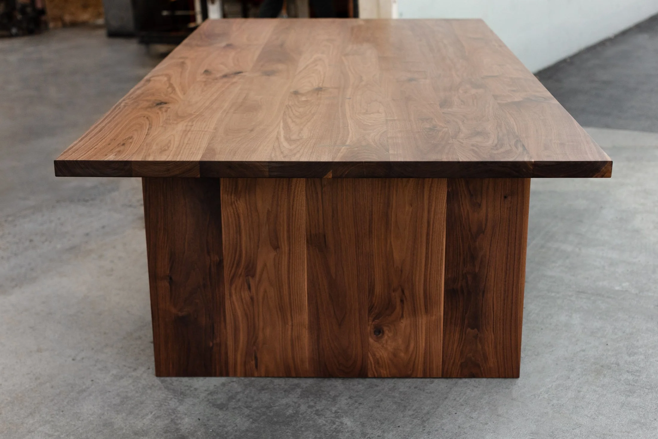 Superior walnut dining table with solid wood legs