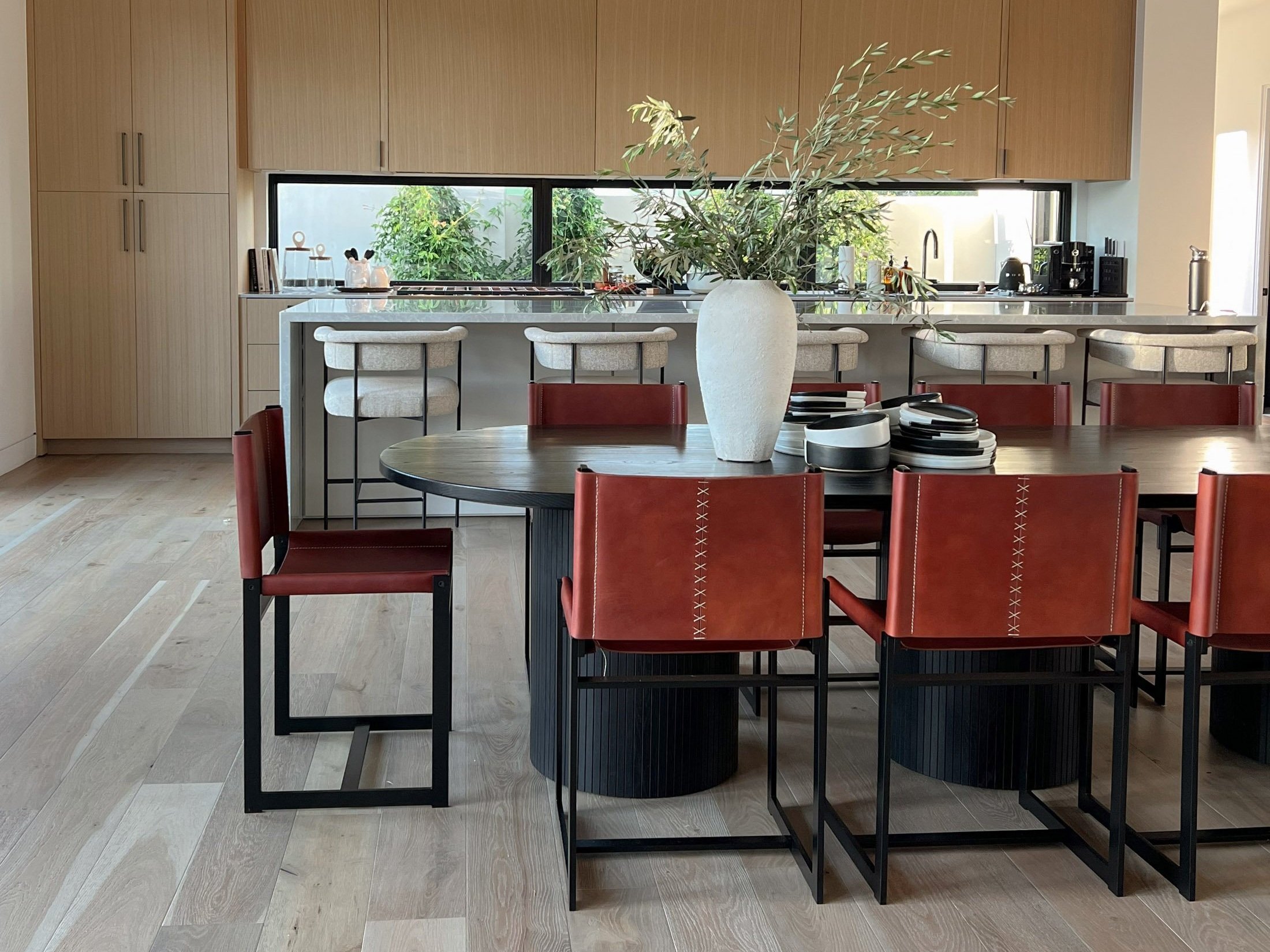 Black Oval dining table with fluted drum legs