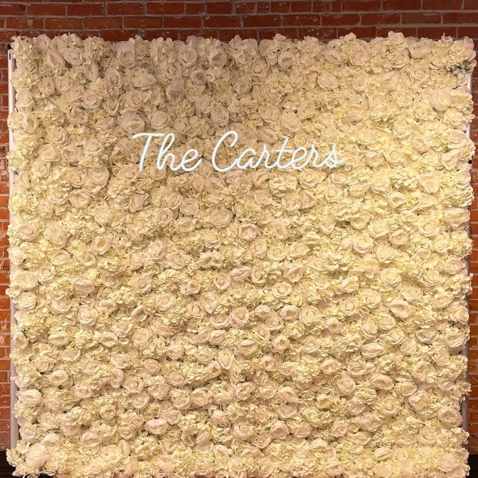 Crisp and clean flower wall with a custom sign