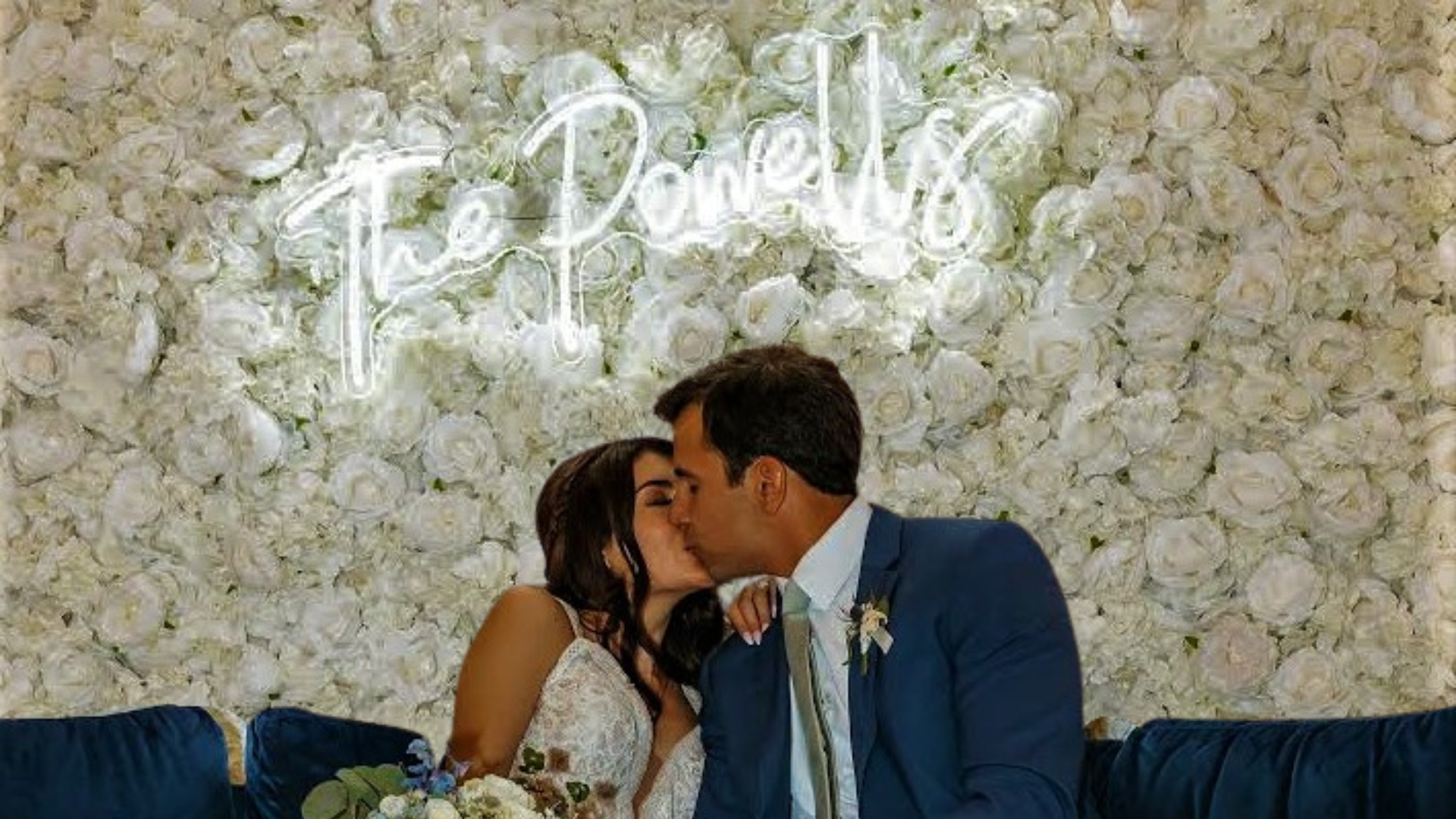 Ivory. and white flower wall with a custom neon sign
