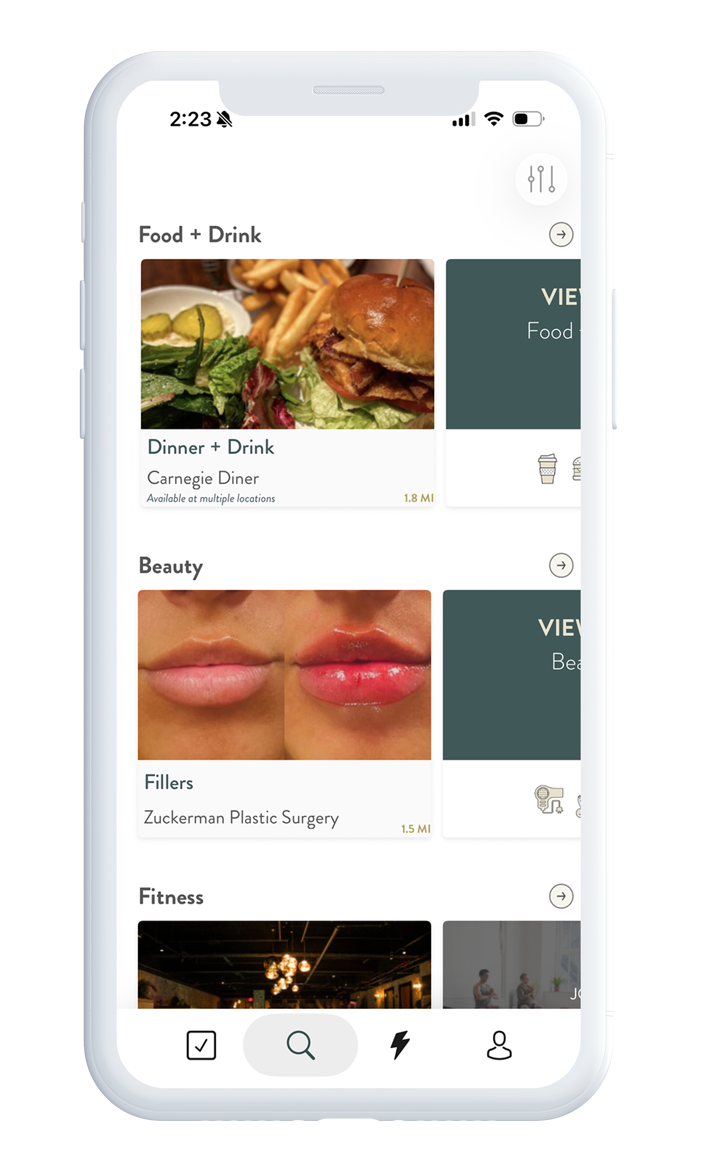 A smartphone screen displaying an app menu with categories for Food + Drink, Beauty, and Fitness. The Food + Drink section shows a picture of a burger with fries, the Beauty section displays a before and after image of lips, and the Fitness section has images of gym activities.