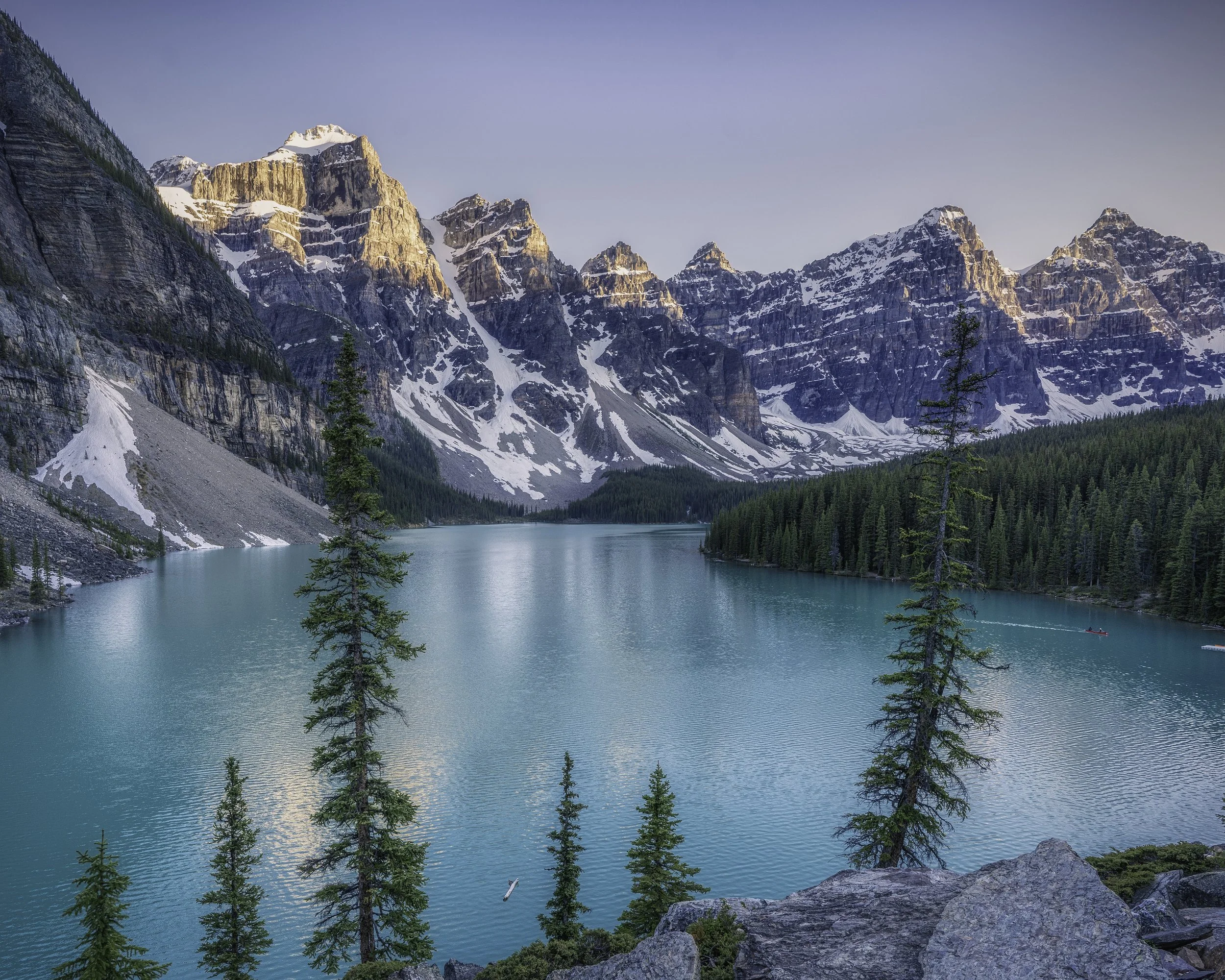 'Sunset at Moraine Lake' 

The last of the summers day light hits the mountain peaks as a  solo canoeist makes their way home.  