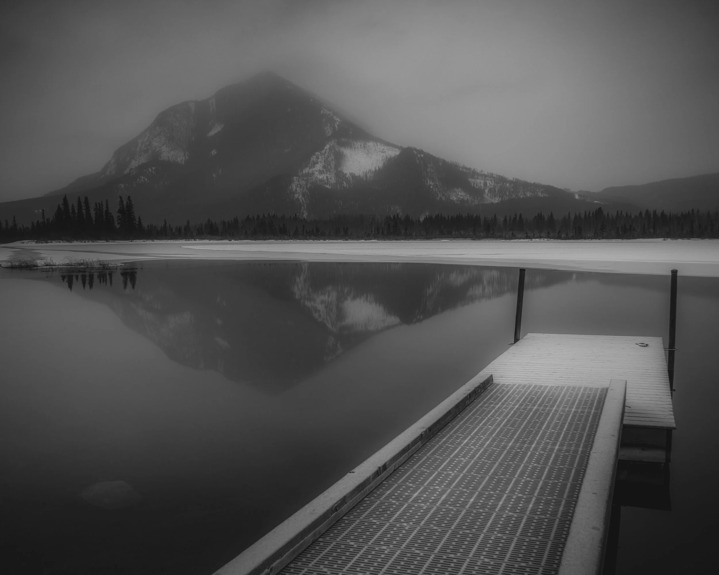 A late evening at Vermilion Lakes in Banff National.  The dock is covered in a layer of frost from the cold  winter weather while a left over glove remains from the days play.