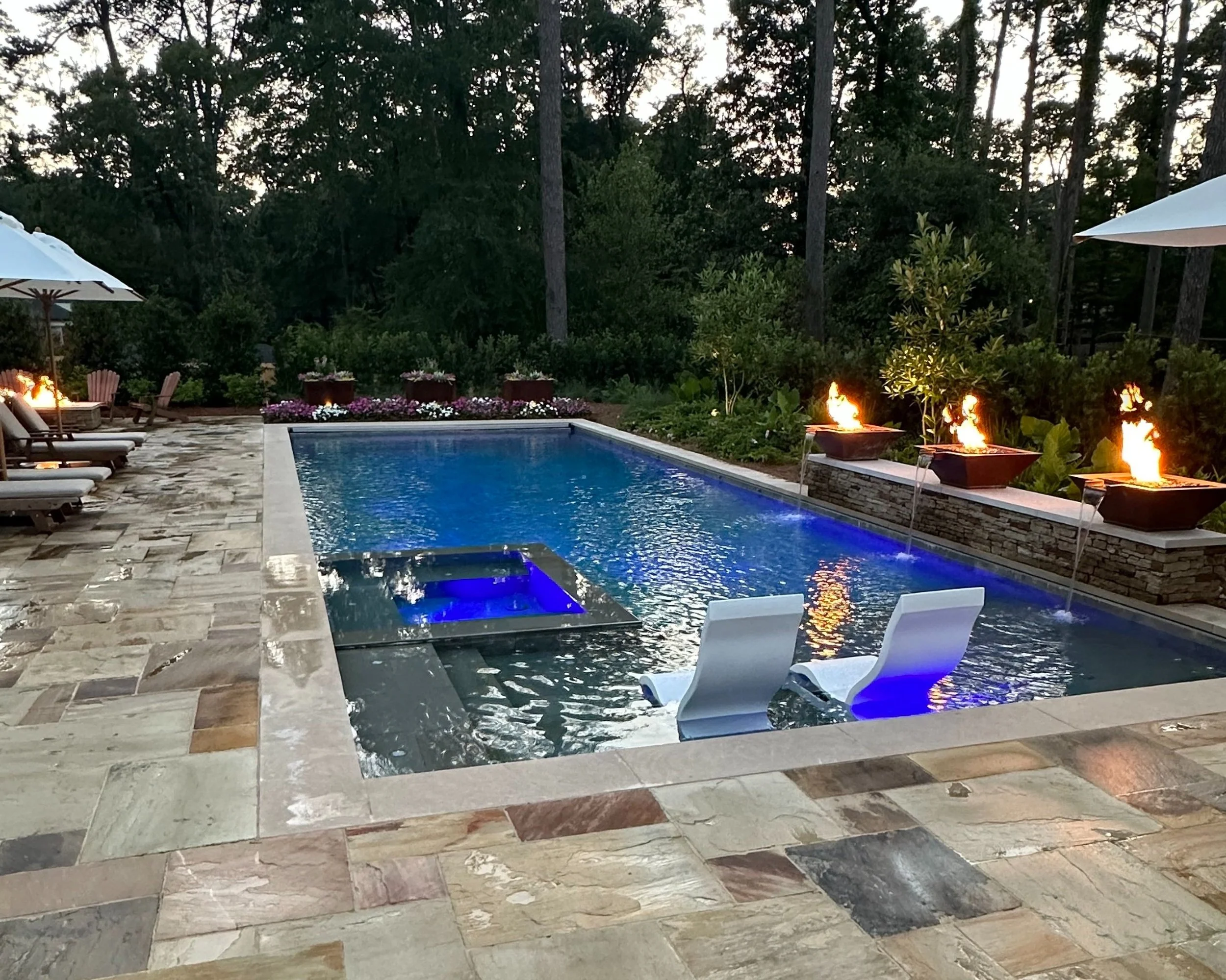 Custom swimming pool, spa, pool decking, lighting, water and fire features all by Waterscapes NWLA.