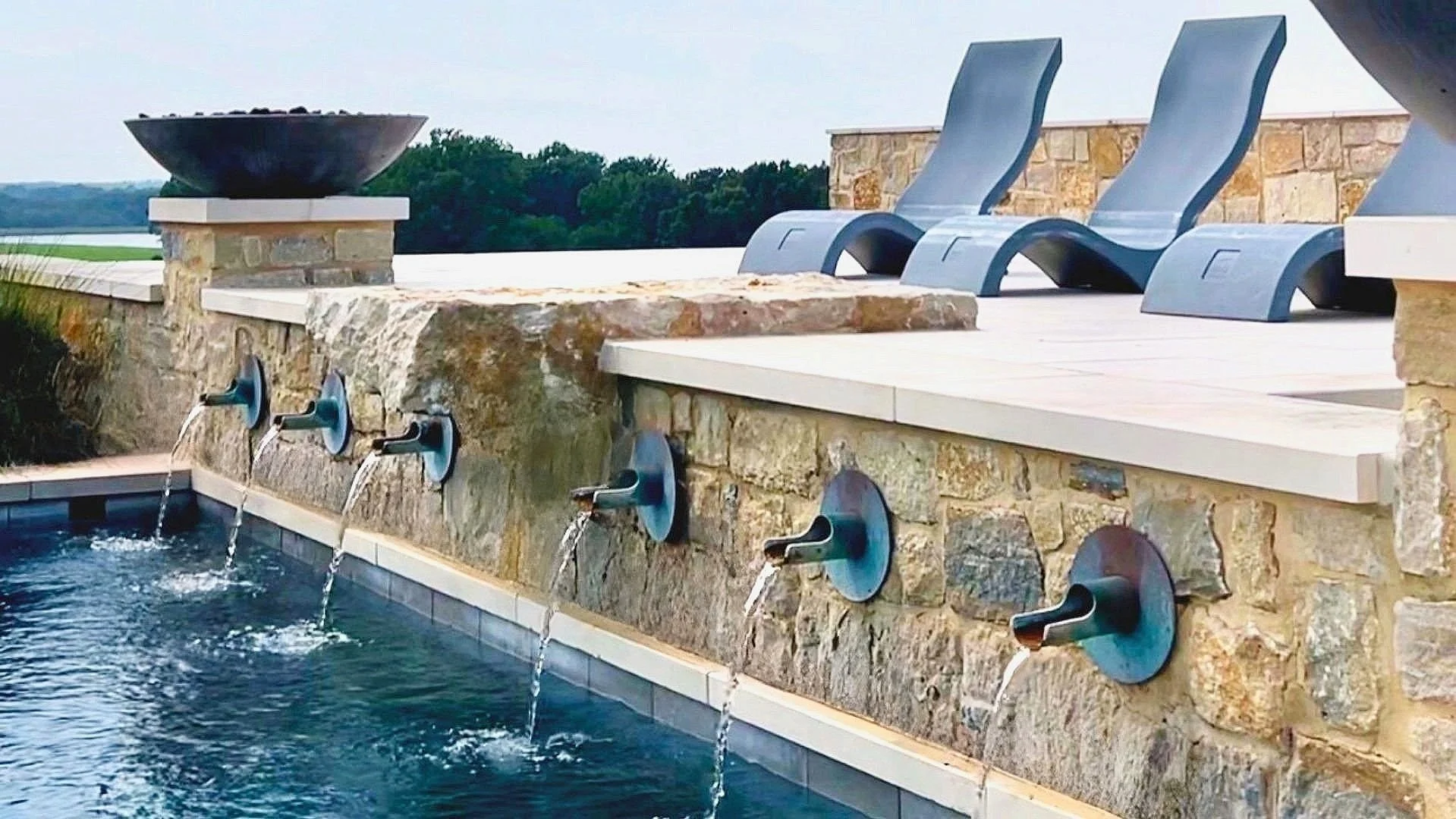 Luxury ranch home designed by Farmer Payne Architects in the piney woods of East Texas is the stunning setting for this rustic, yet elegant swimming pool, spa, and water feature engineered and constructed by Waterscapes.  Residence built by Hamilton