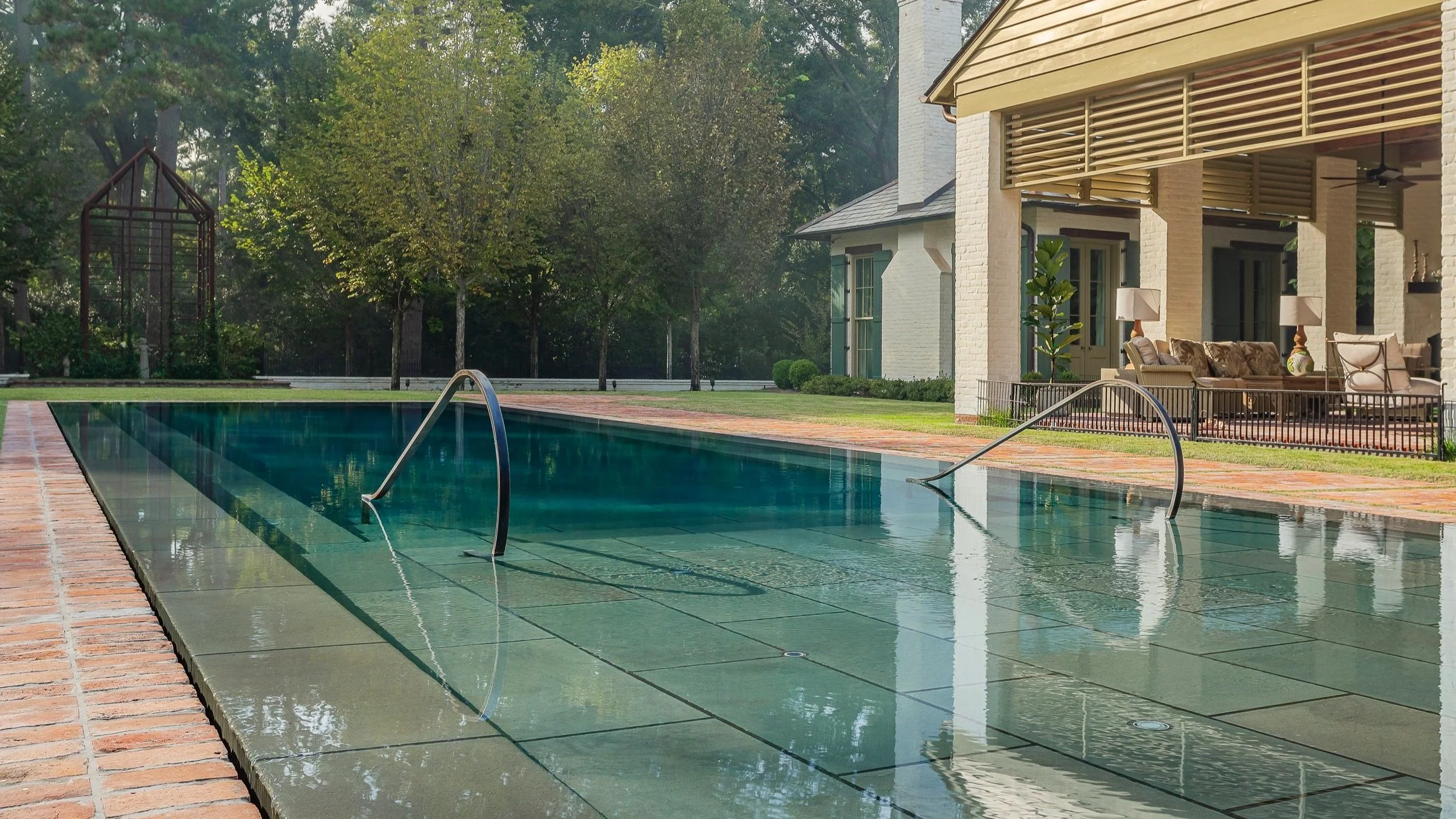 ZERO EDGE EXPANSIVE SWIMMING POOL WITH CUSTOM DESCENDING  STEEL RAILING